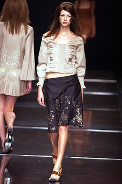 beige silk fitted blouse with black skirt