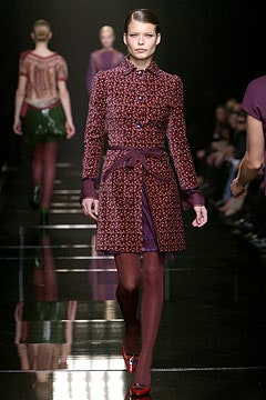 fitted purple coat with pleated skirt