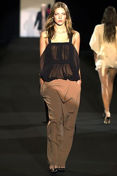 black sheer top with beige pants