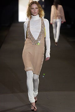 beige sleeveless dress with white leggings