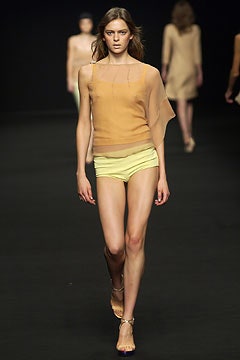 beige silk asymmetric top with yellow shorts