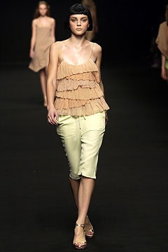 beige ruffled top and yellow pants