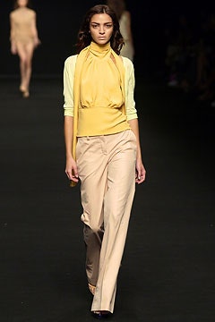 yellow fitted top with beige pants