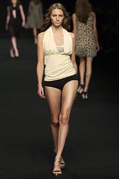 beige fitted top with black swimsuit