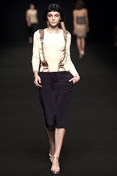 beige fitted top with black relaxed pants