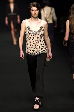 beige beaded sleeveless top with black pants