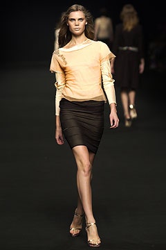 fitted orange top with black skirt