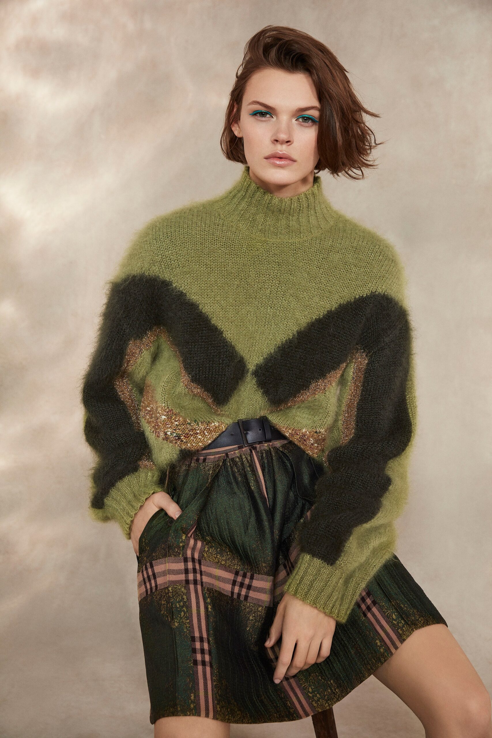 green color-blocked sweater and mini skirt