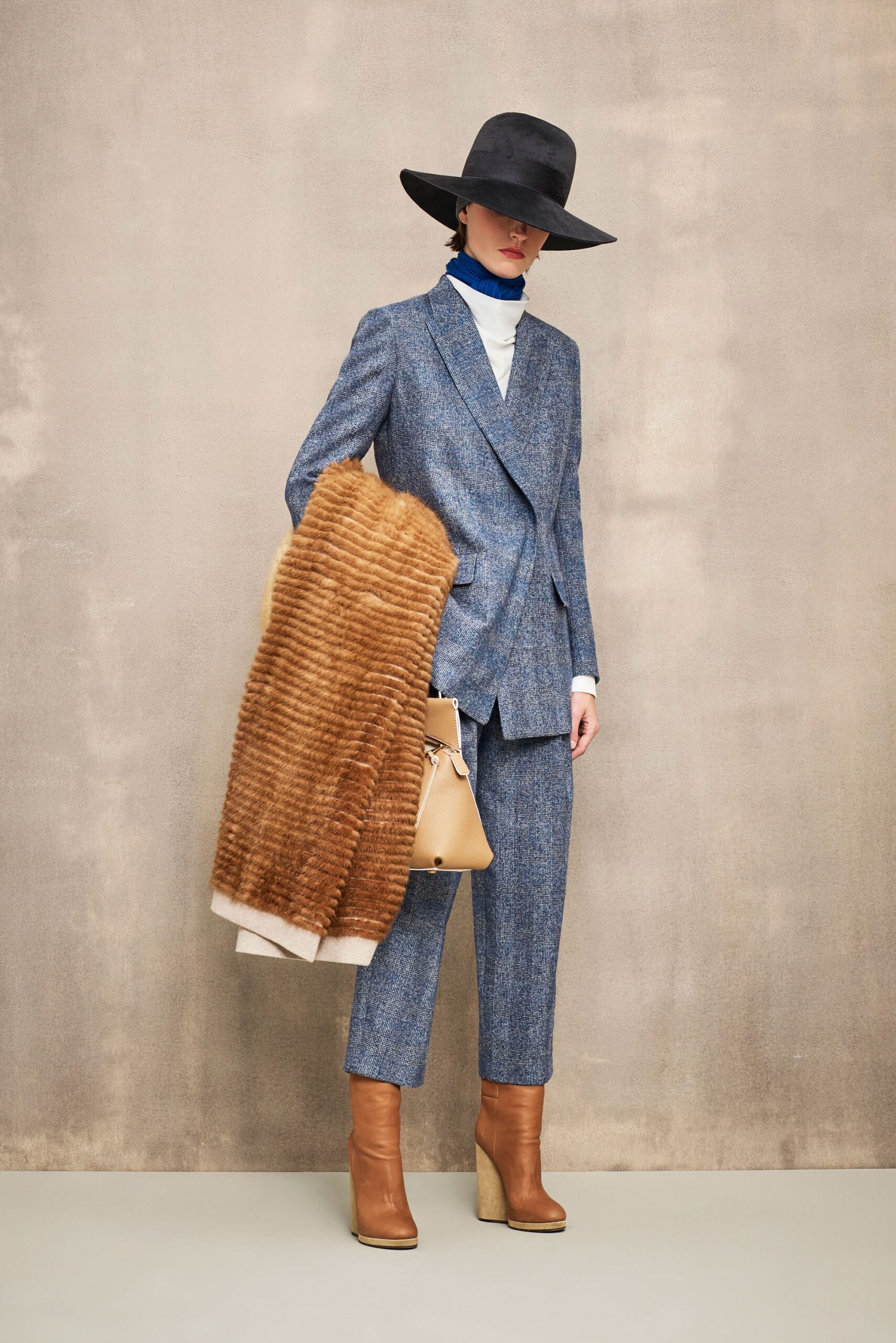 blue tailored suit with black hat