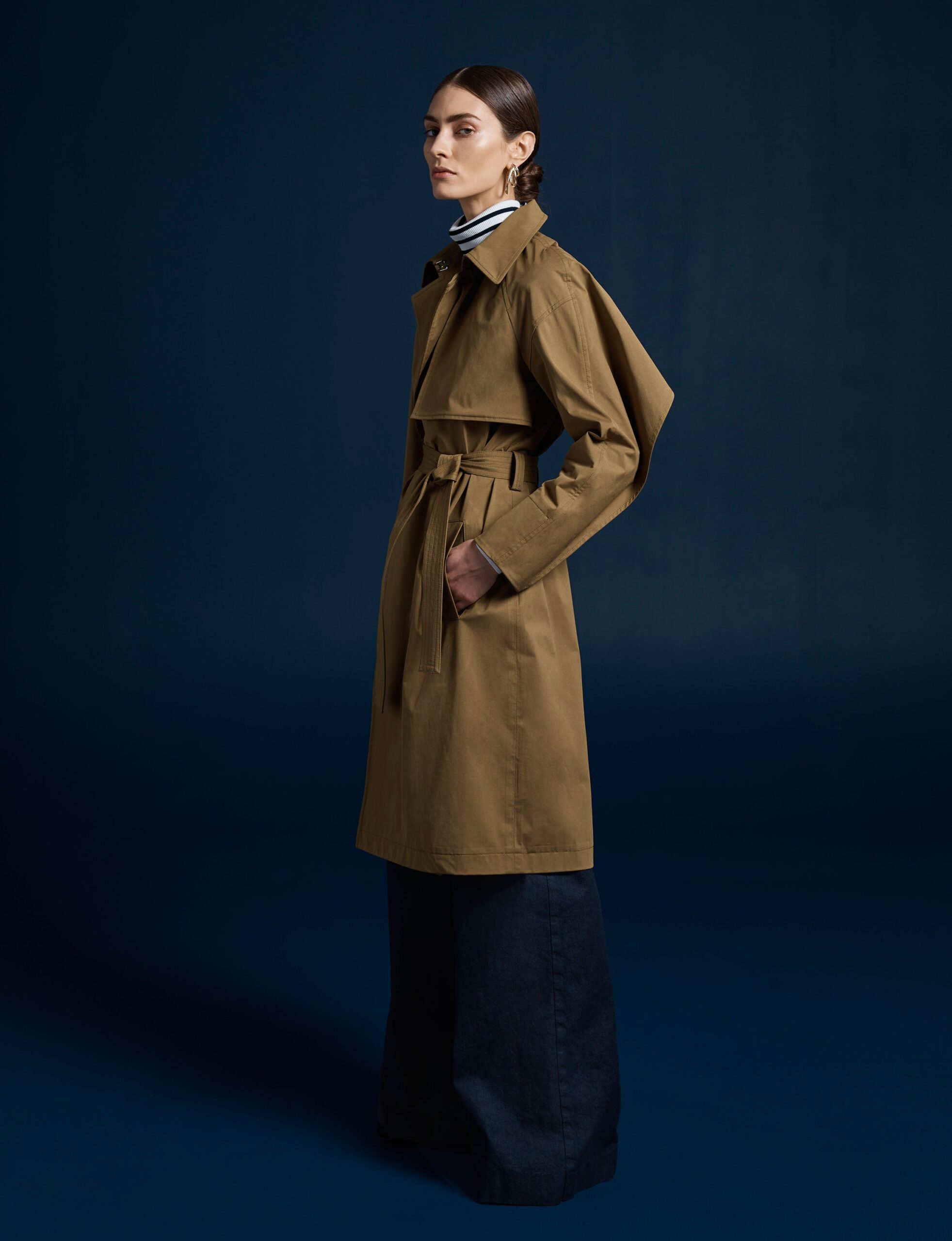 brown cotton trench coat with blue denim pants