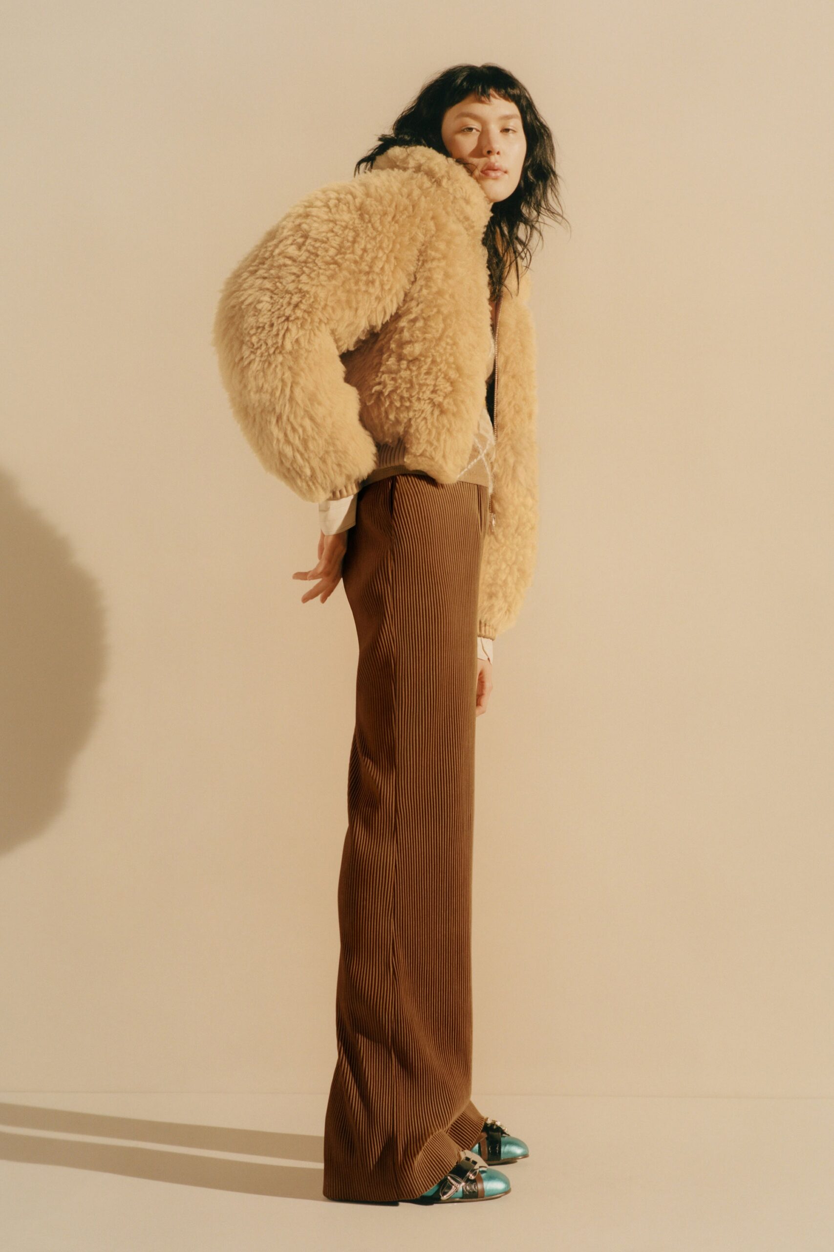 beige faux-fur jacket and brown pants
