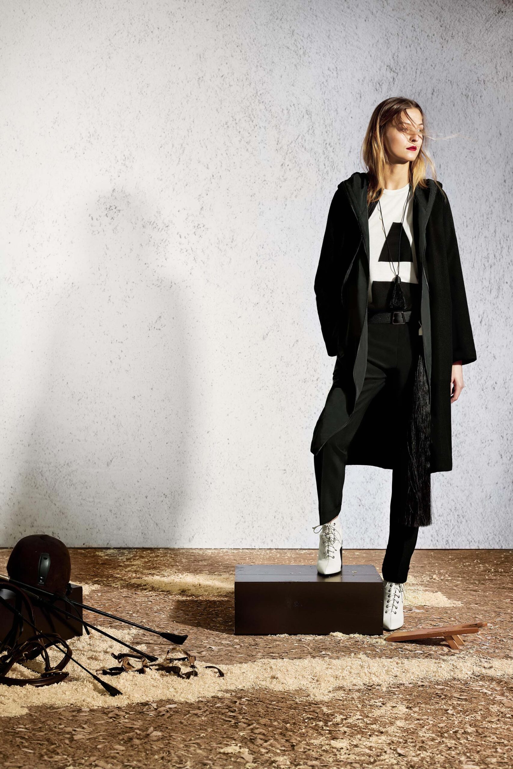 black coat white top tailored pants