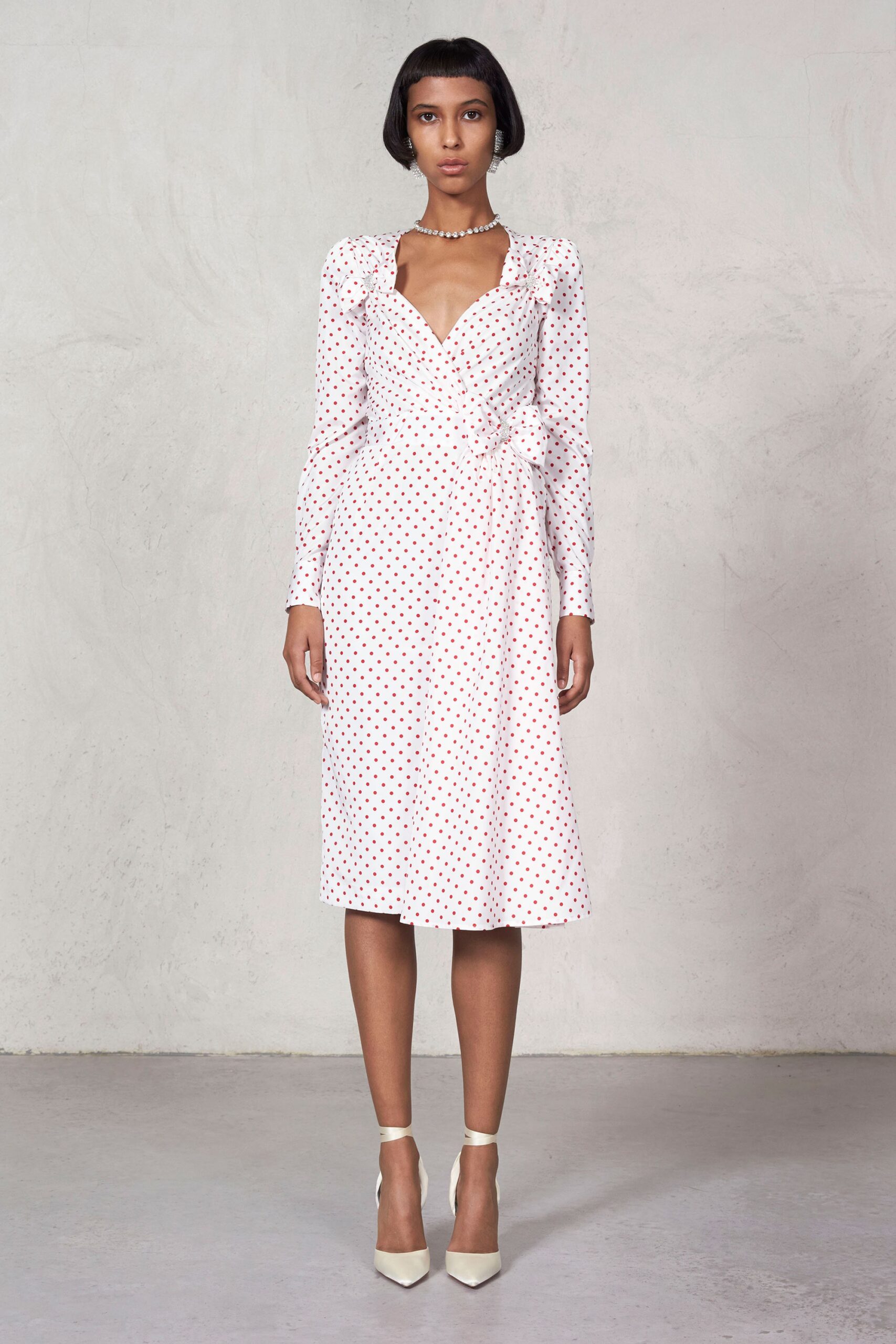 white polka-dot fitted dress