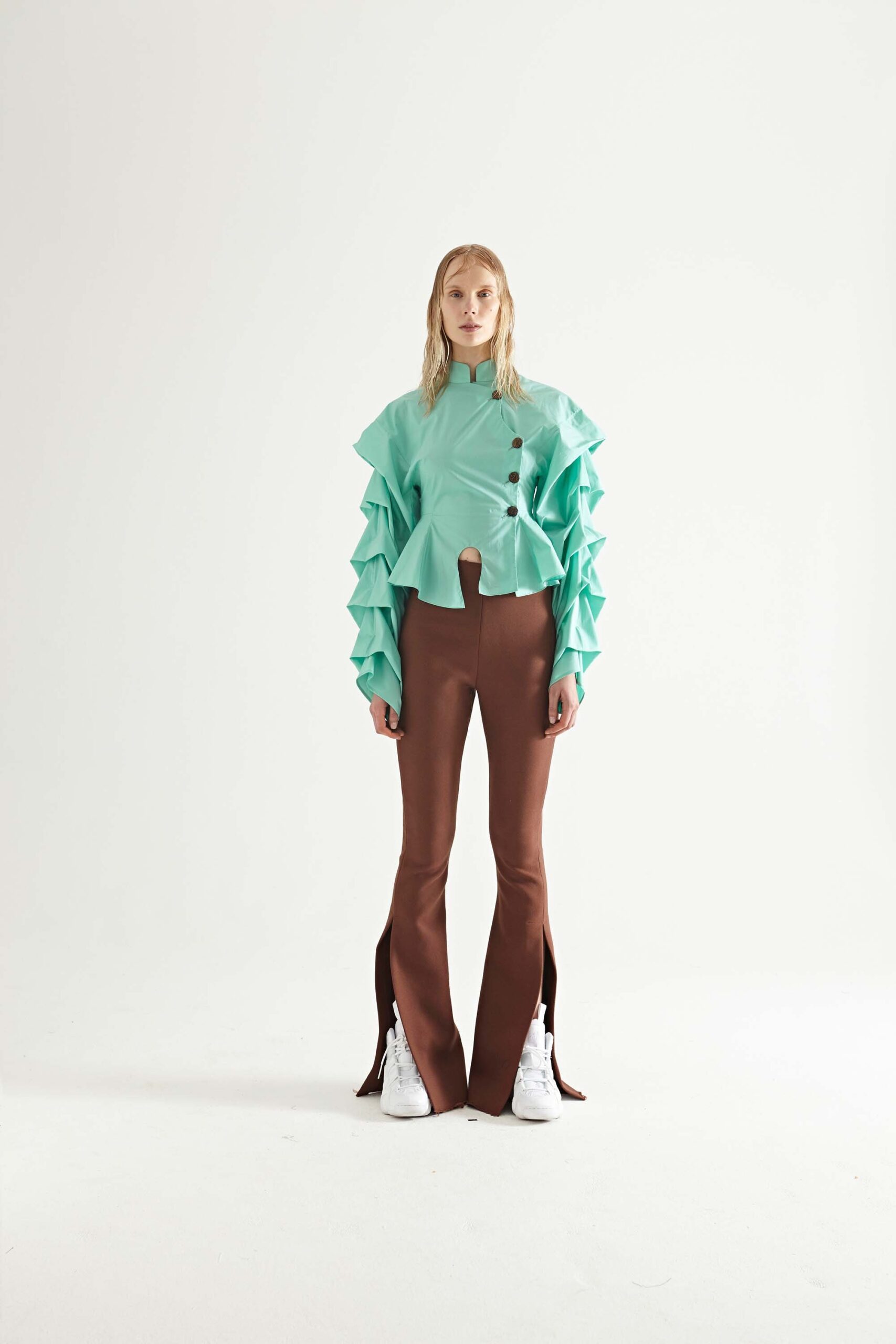 mint ruffled top with brown flared pants