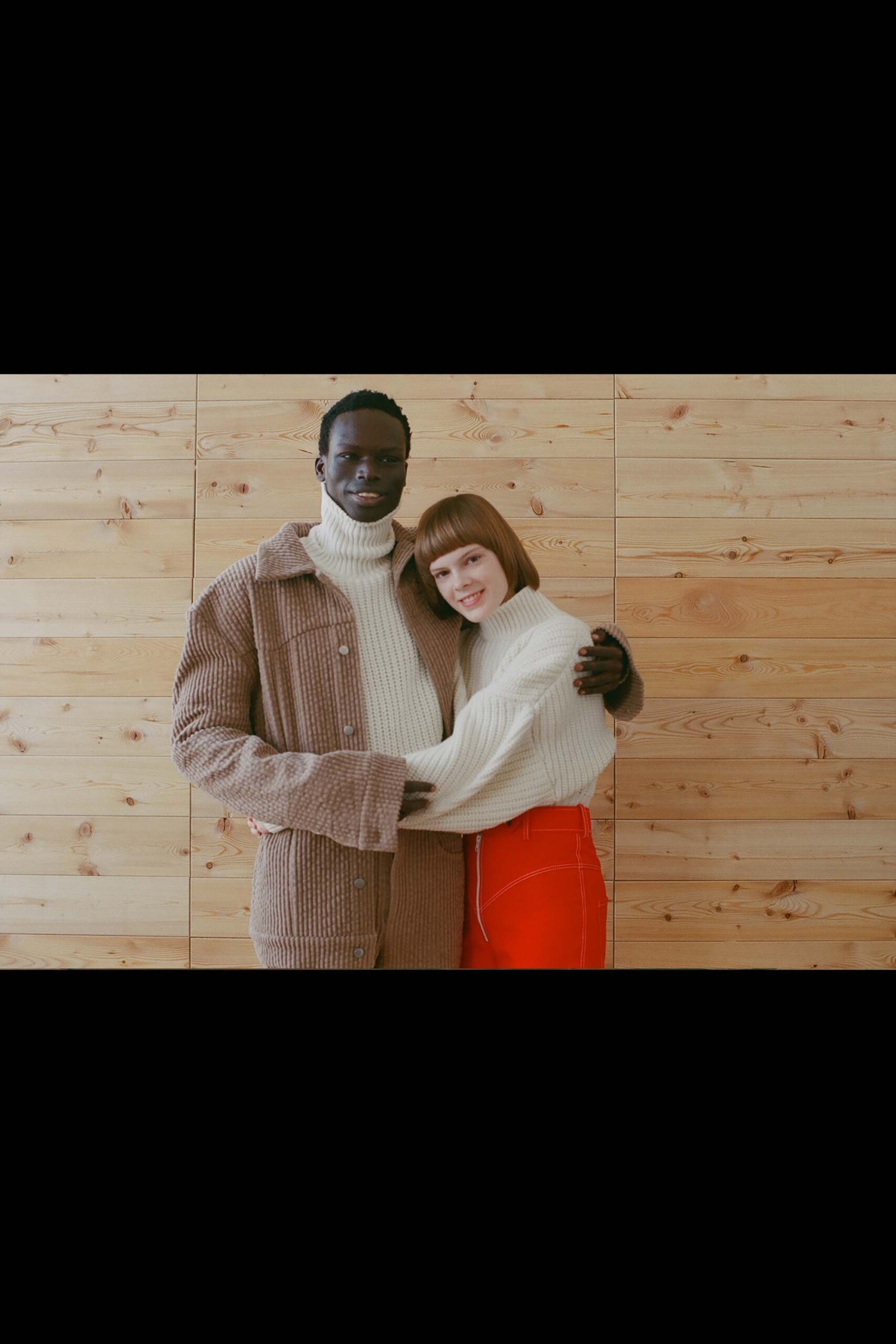white sweater beige coat red pants