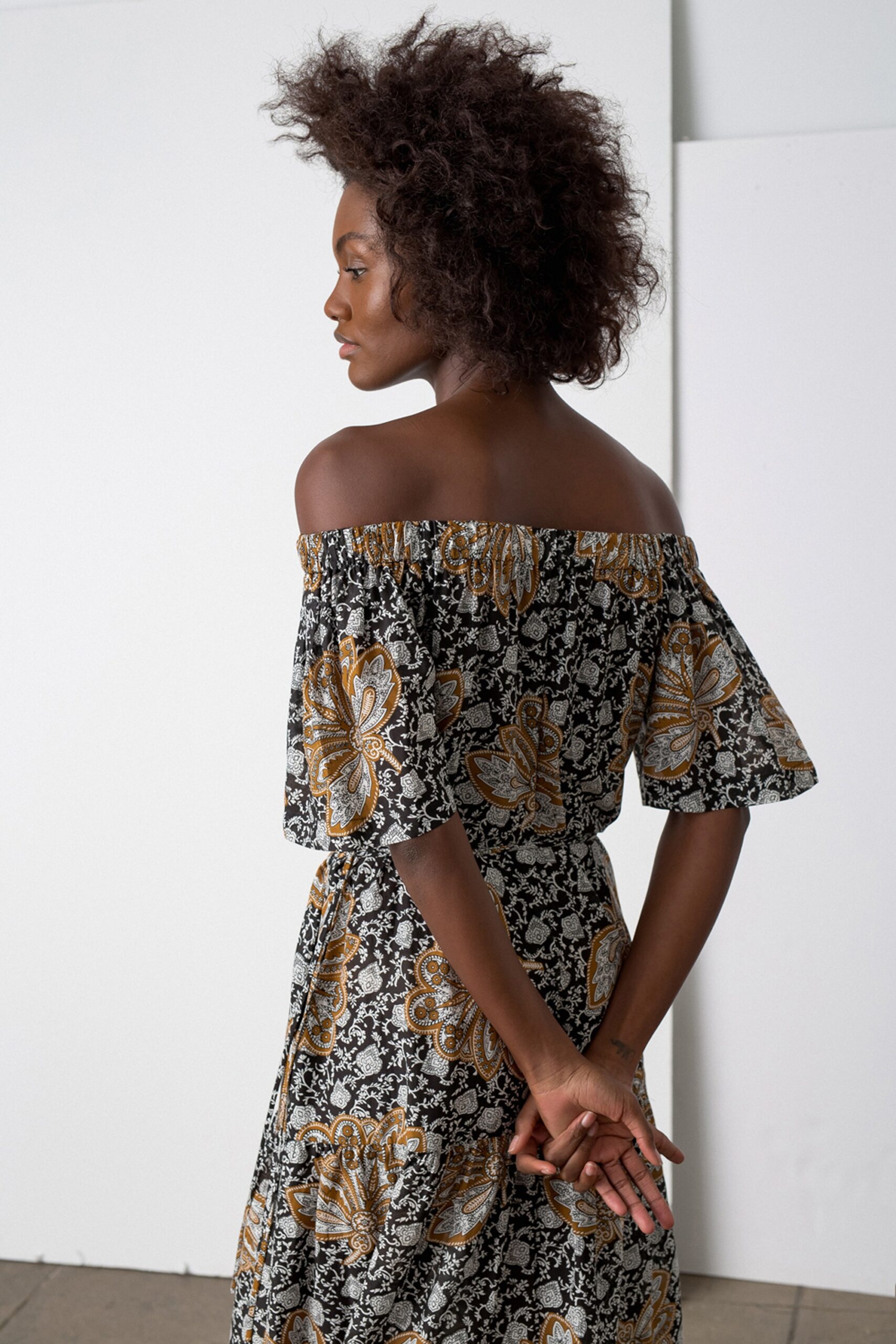 black and gold printed off-shoulder dress