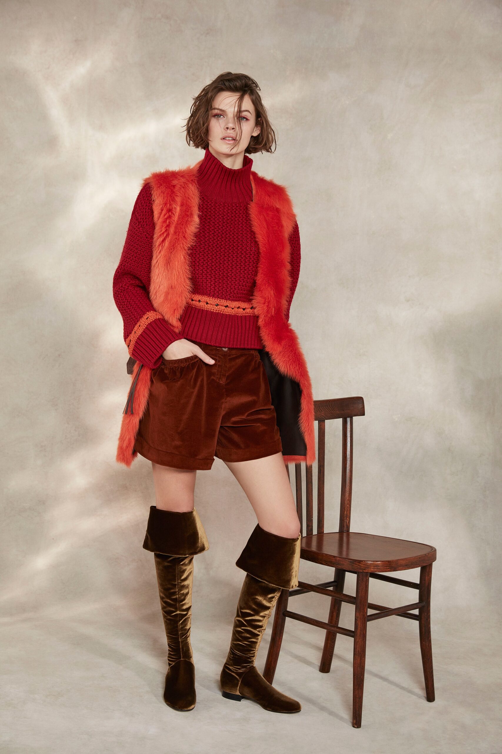 red wool turtleneck sweater with brown velvet shorts