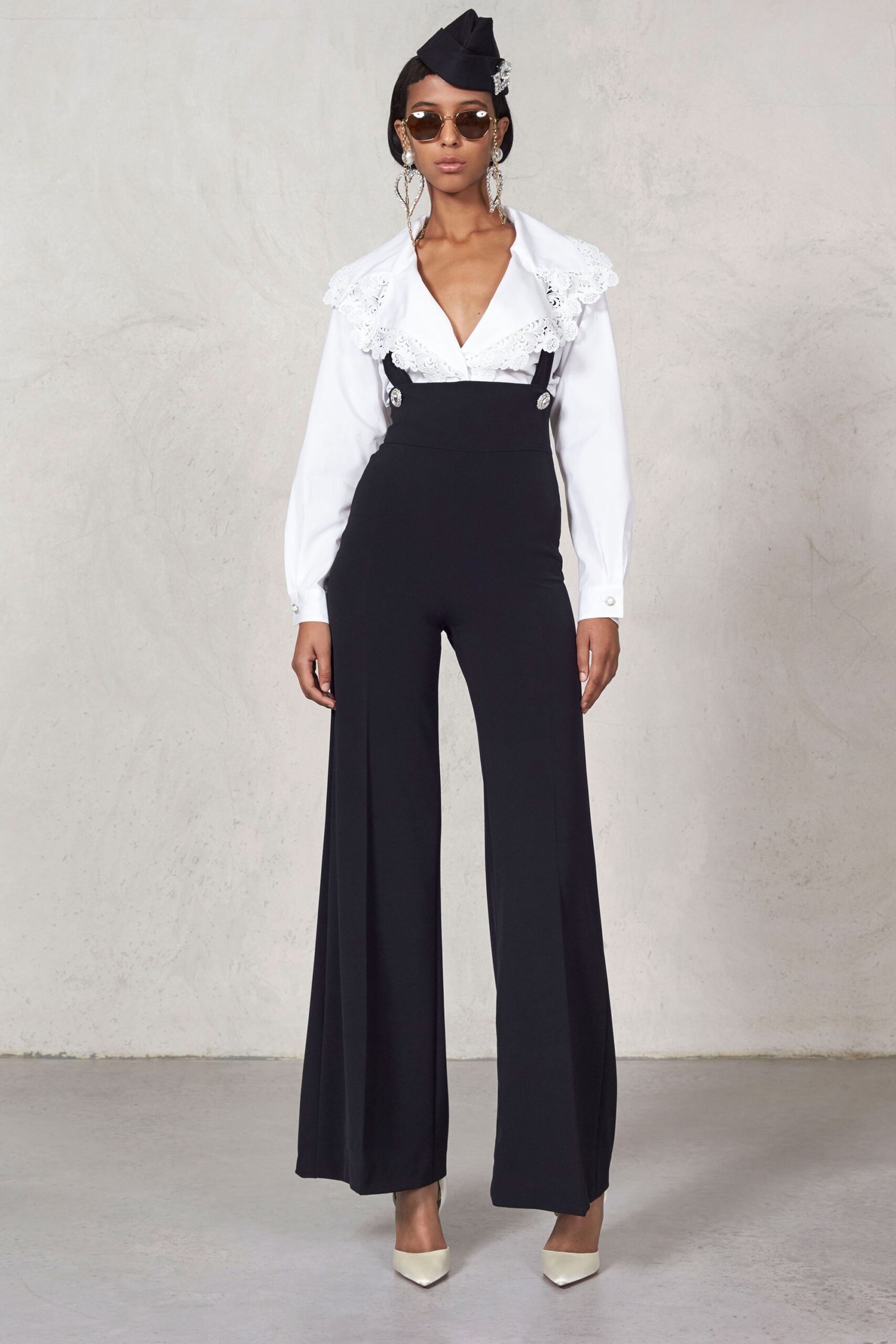 white ruffled blouse and black wide-leg pants