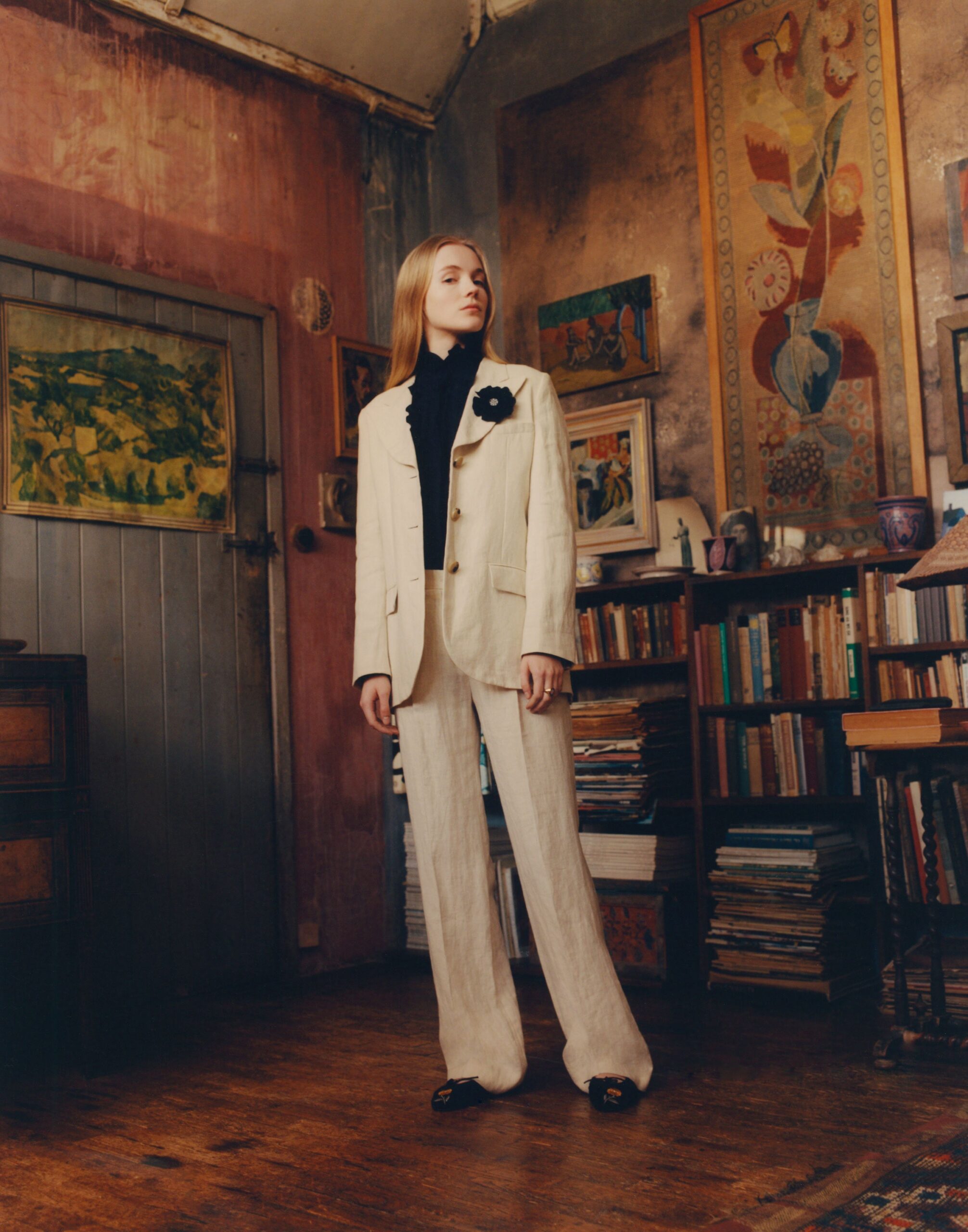 beige tailored suit with black turtleneck