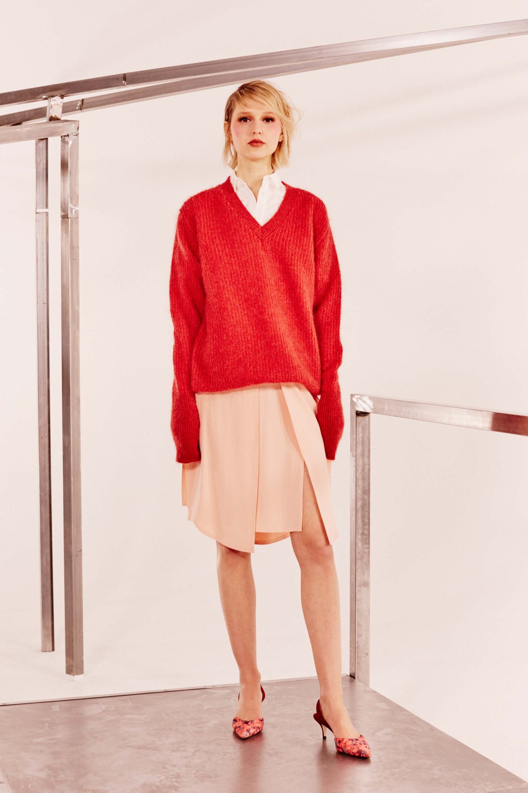 oversized red sweater with pleated pink skirt