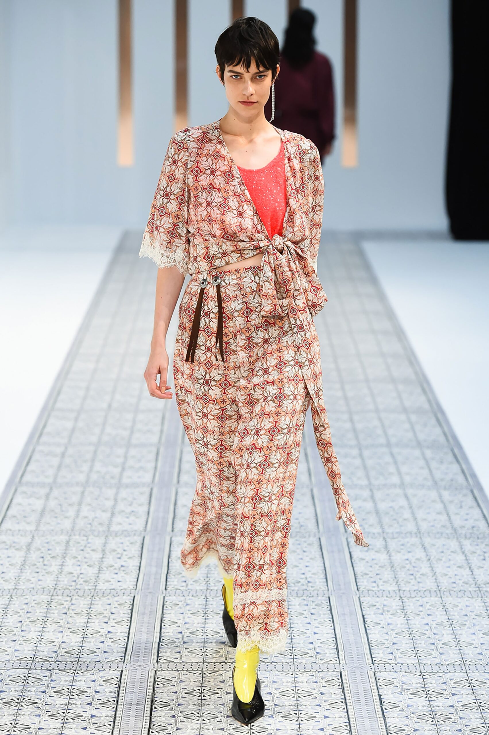 A relaxed red and beige dress with long sleeves, a V-neckline, and a flared silhouette.