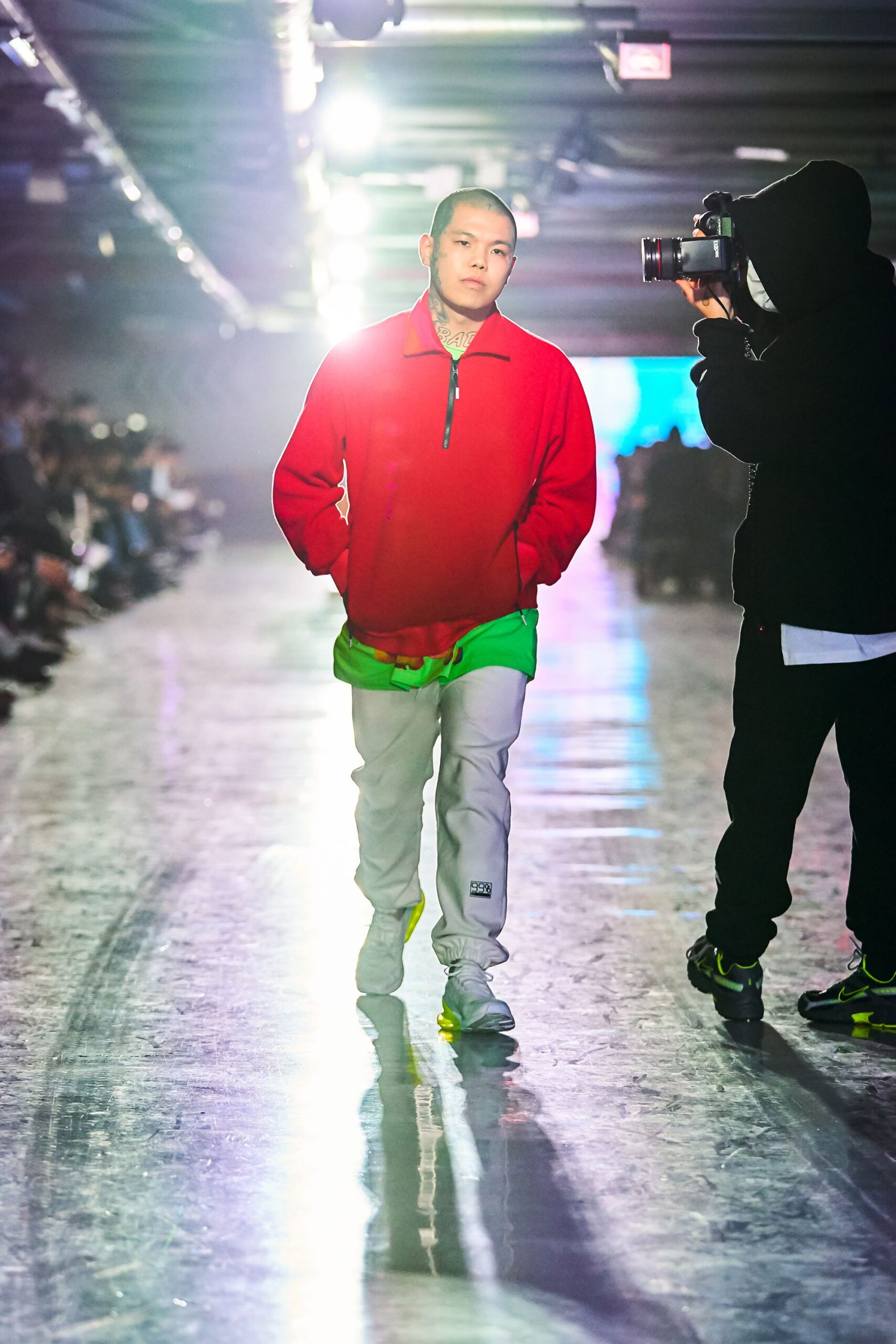 A relaxed fit color-blocked jacket in red and green paired with gray pants.