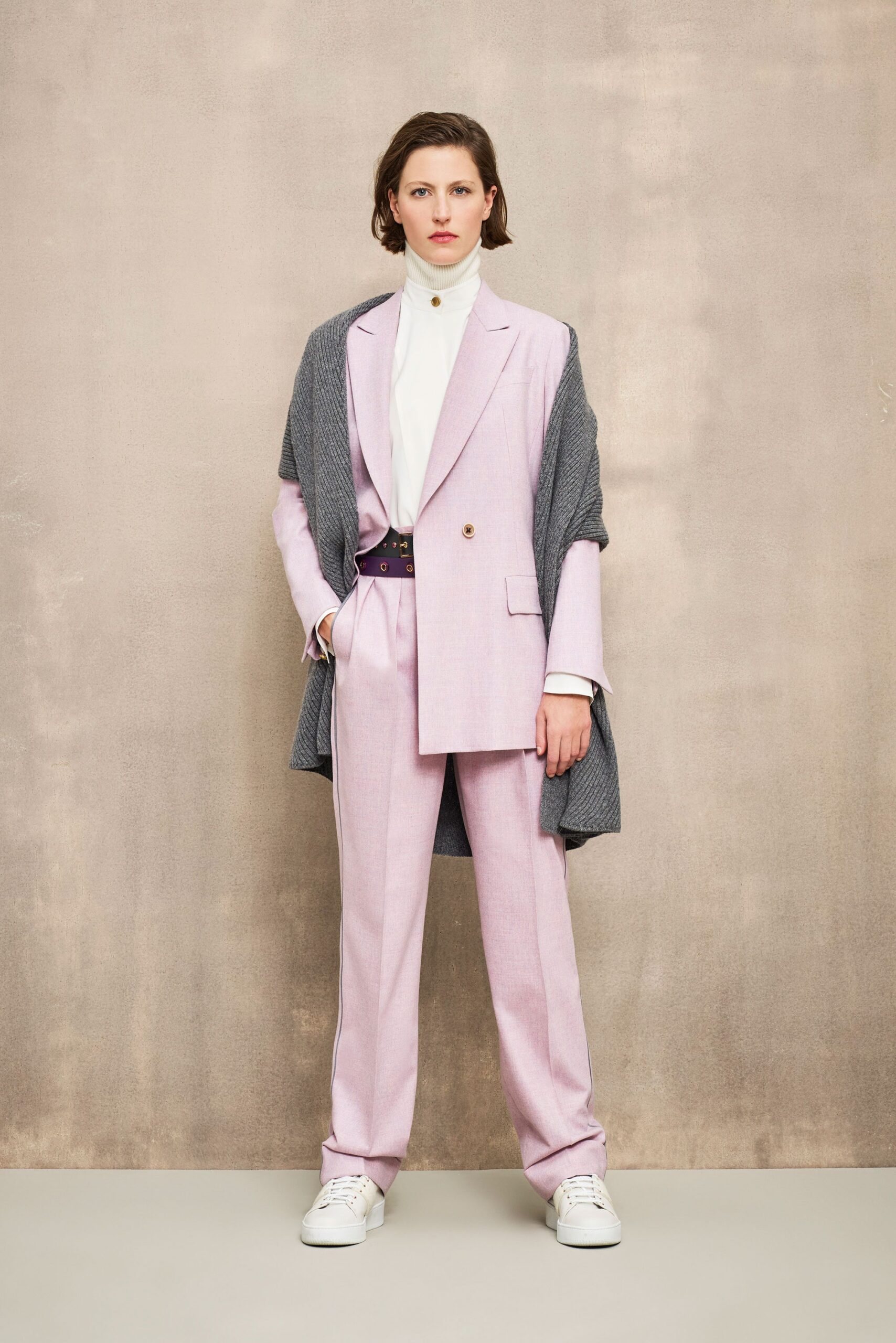 pink tailored suit with gray cape