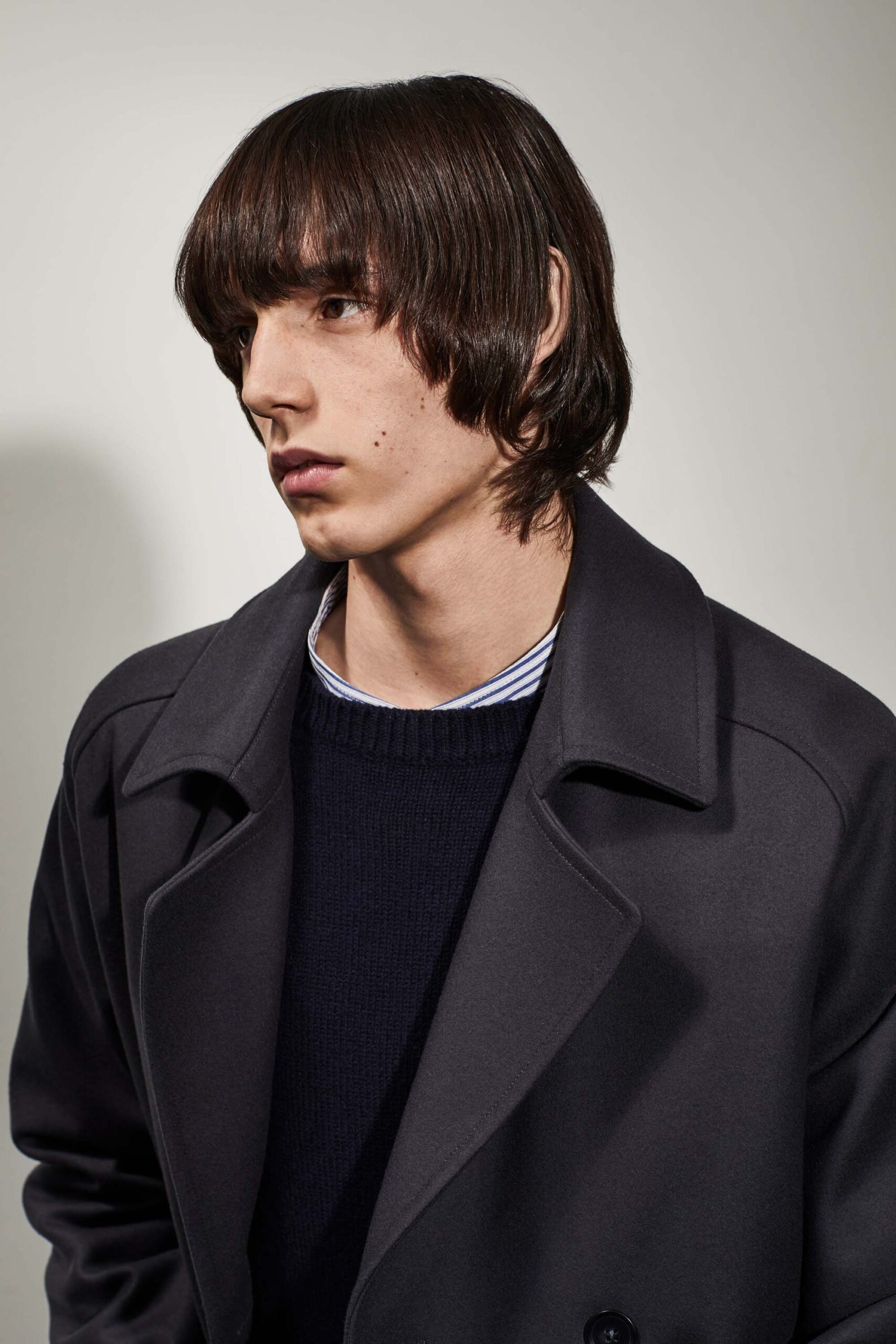black wool coat and navy sweater