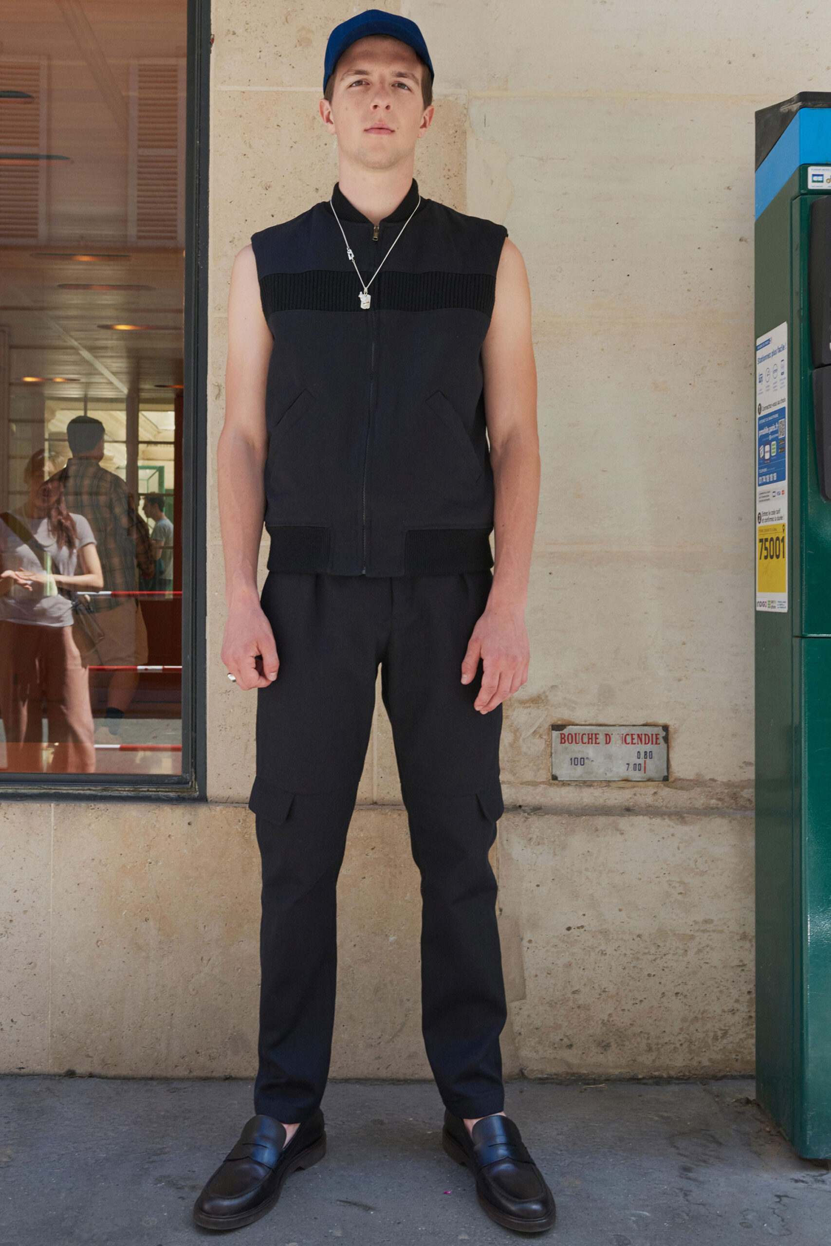 black fitted vest and cargo pants