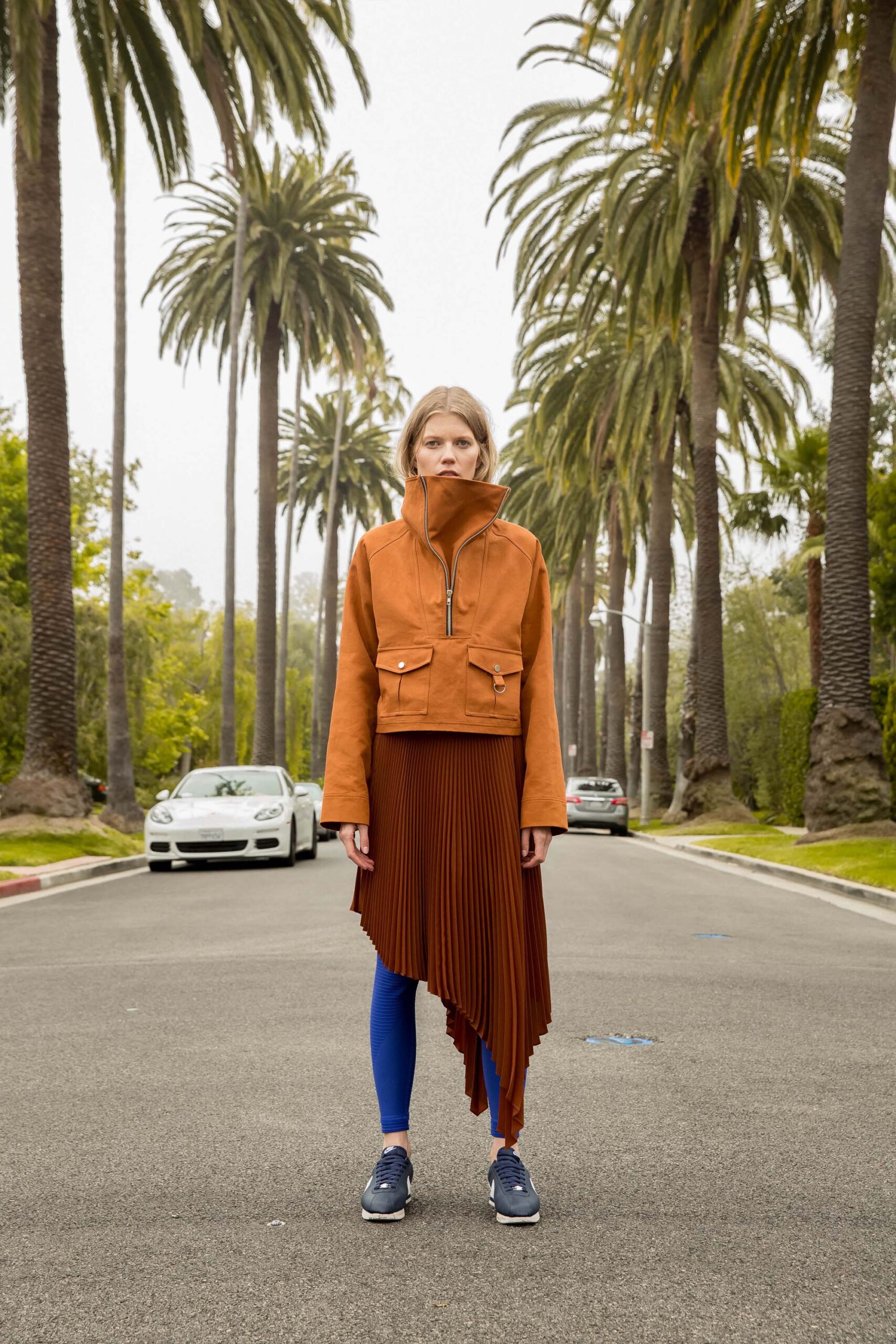 orange jacket brown pleated skirt