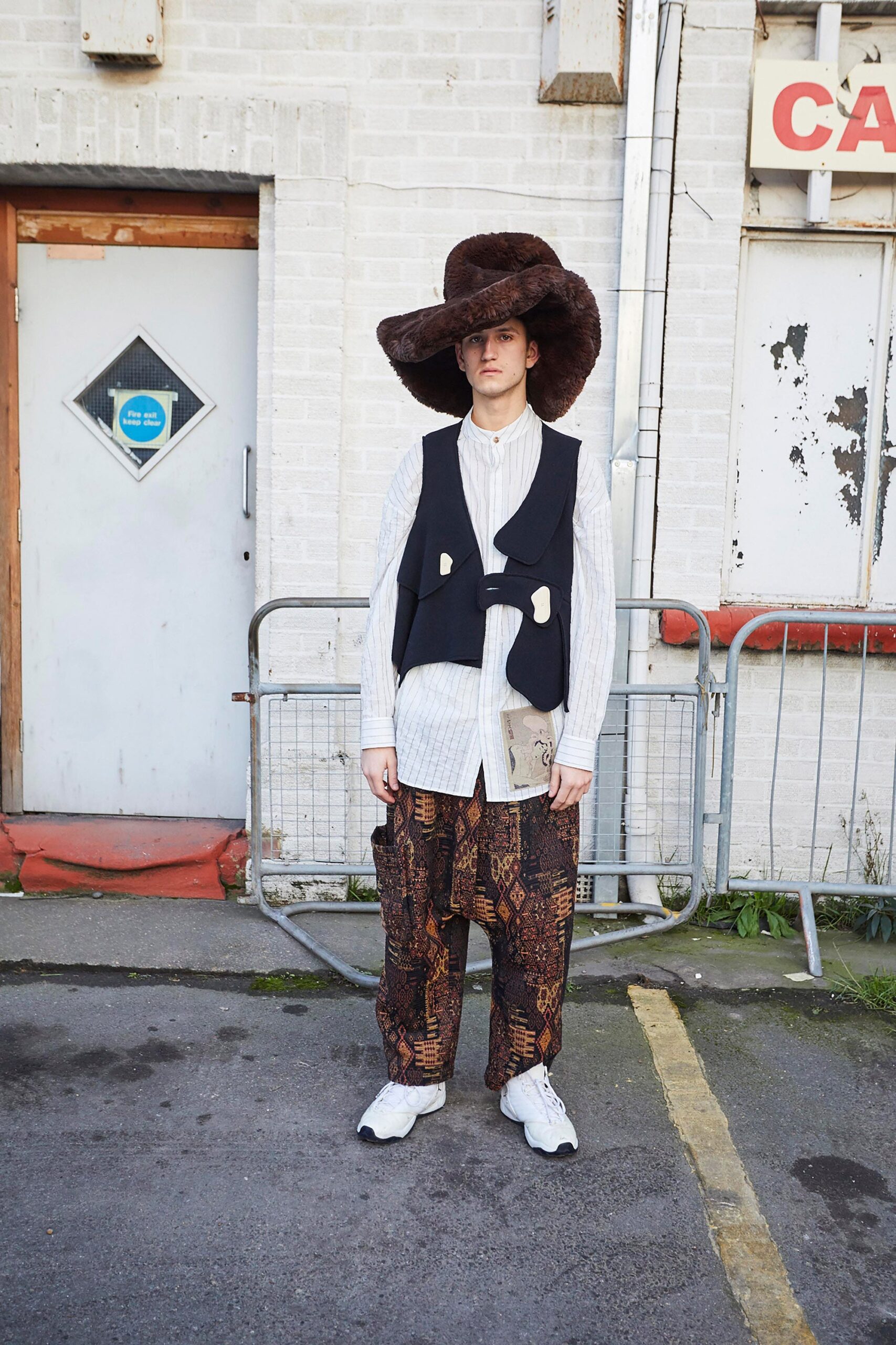 white shirt black vest brown pants