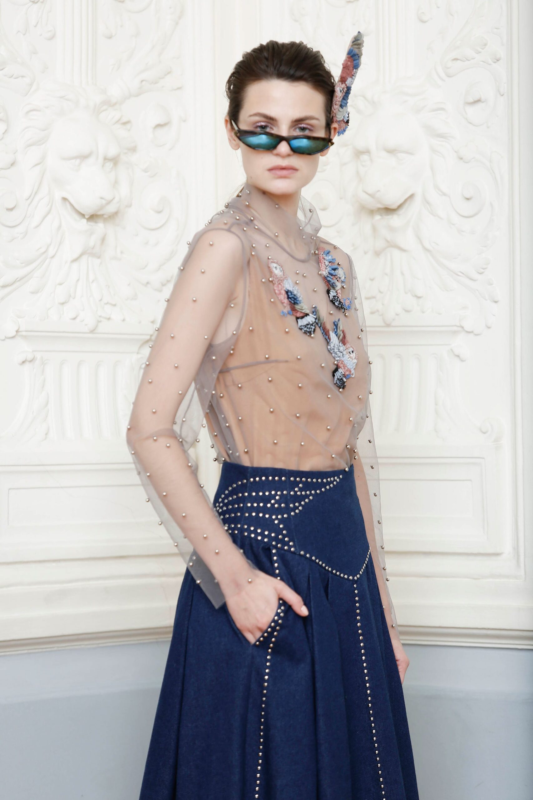 beige sheer top with blue skirt