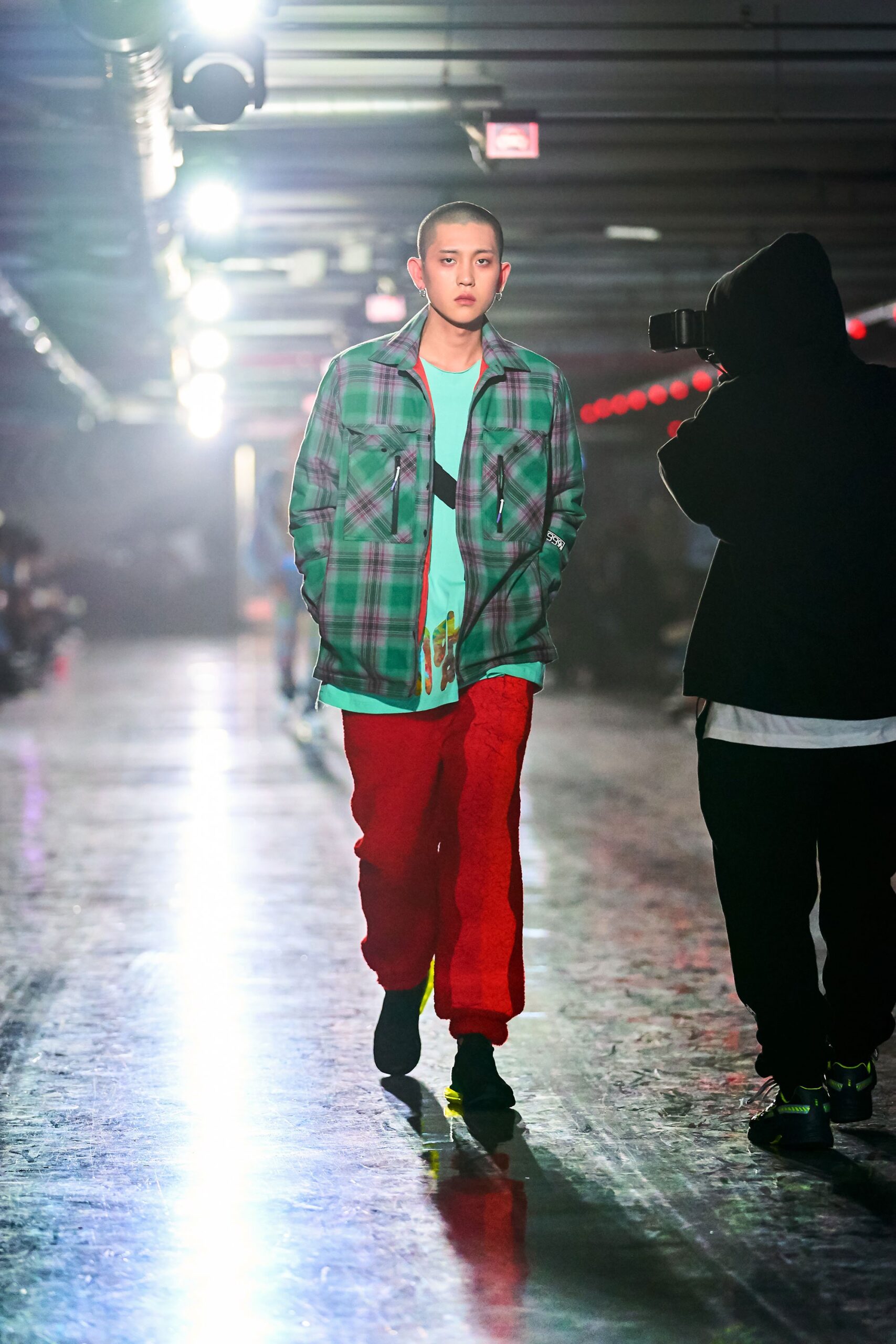 A relaxed fit green checked jacket paired with red pants, showcasing a layered style.