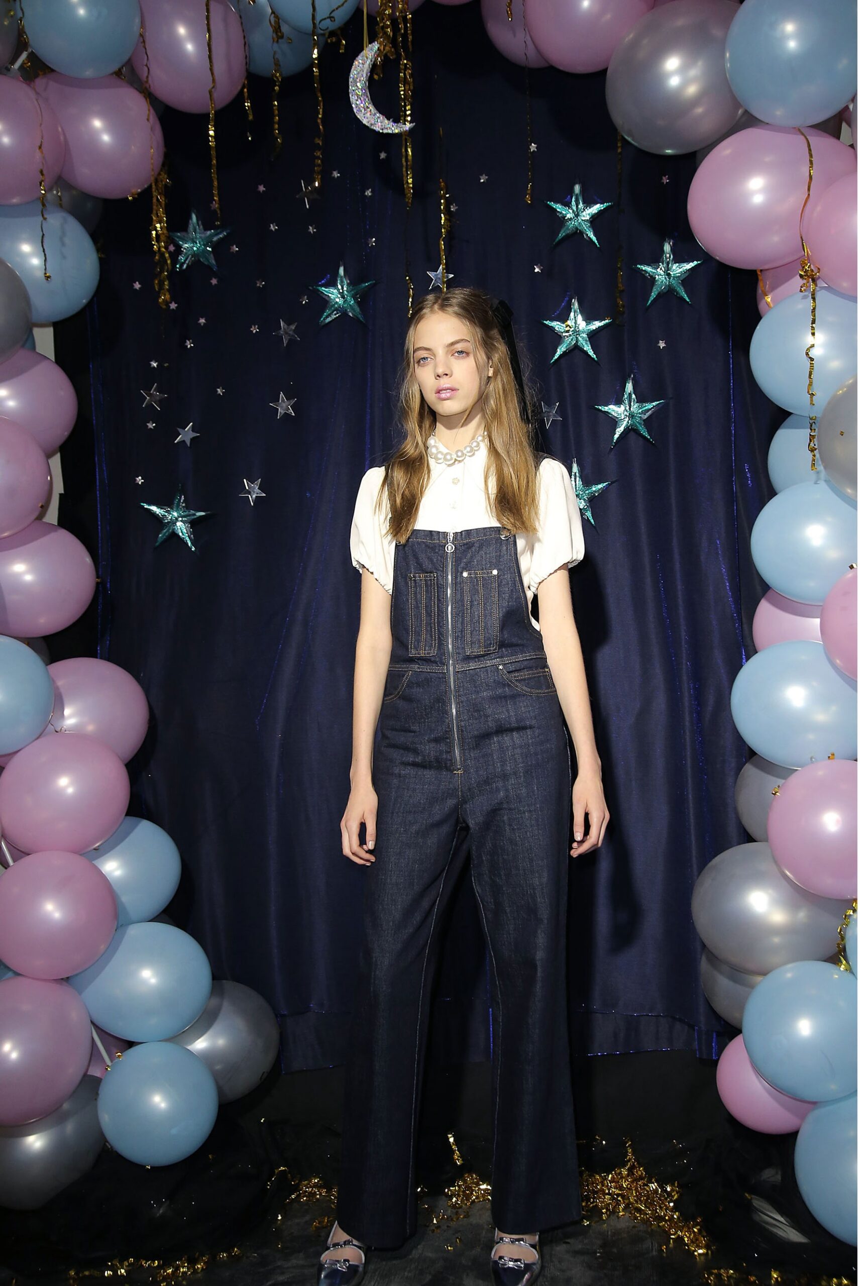 blue denim overalls with white blouse