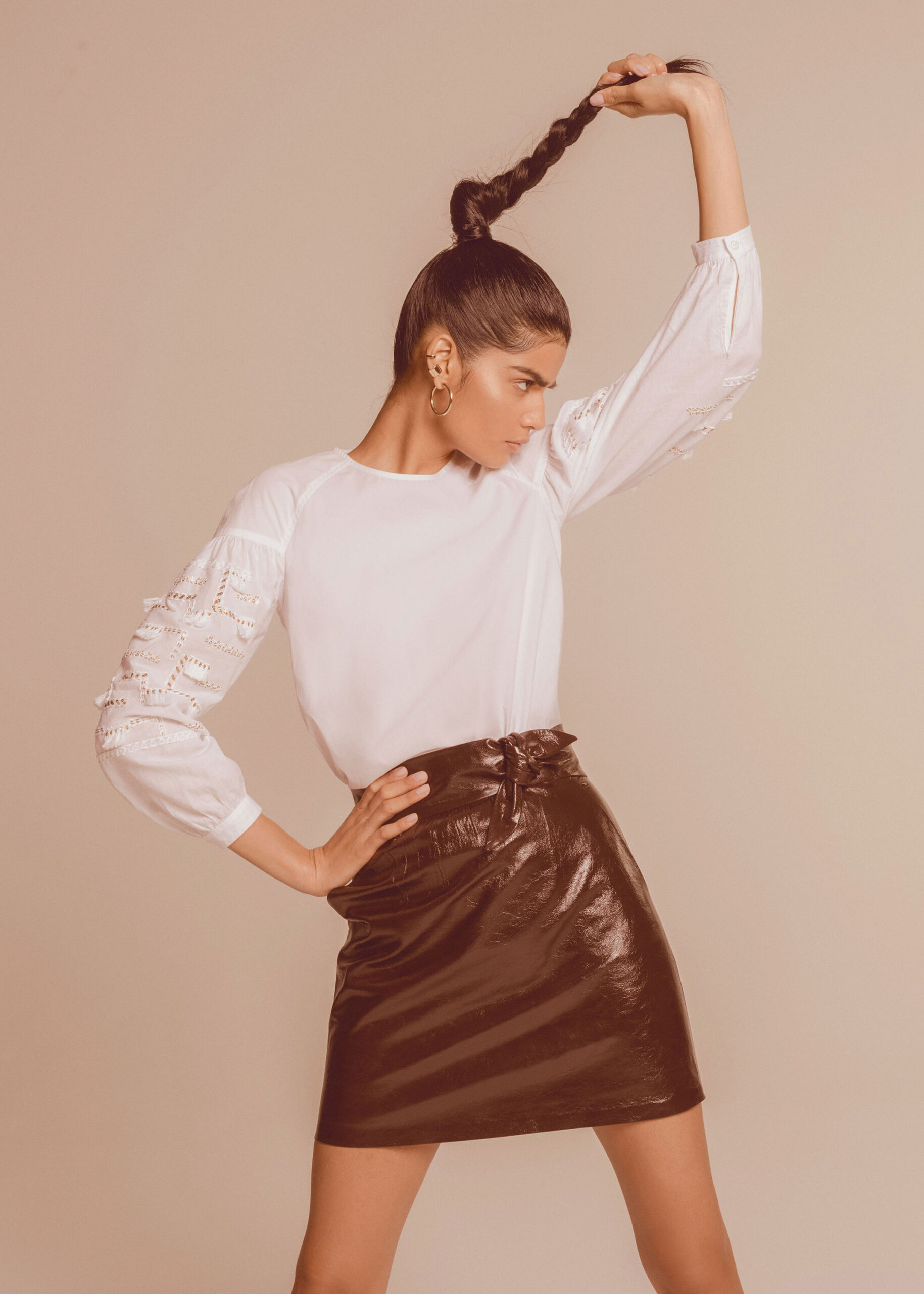 white embroidered blouse and brown leather skirt