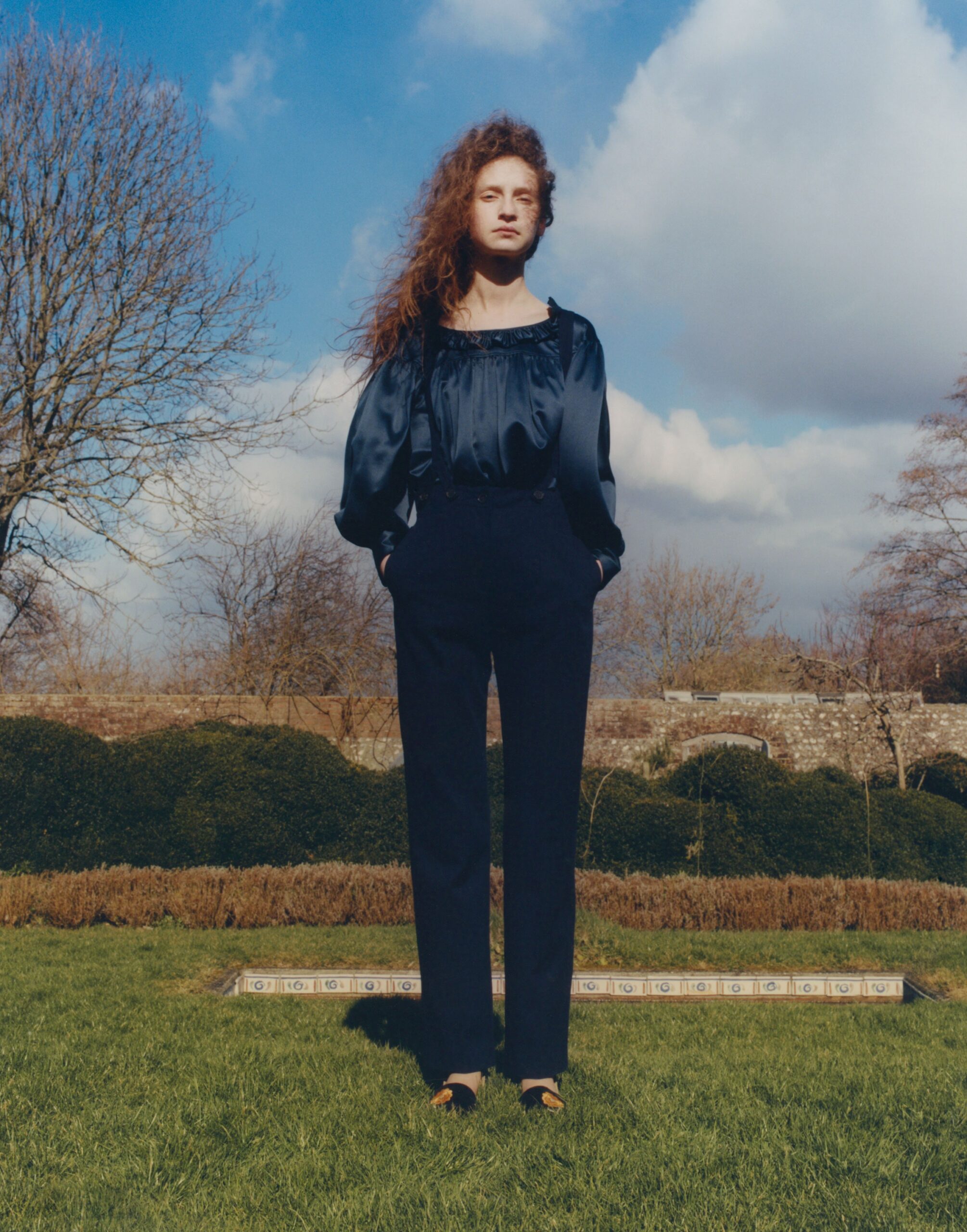 black silk blouse and navy tailored pants