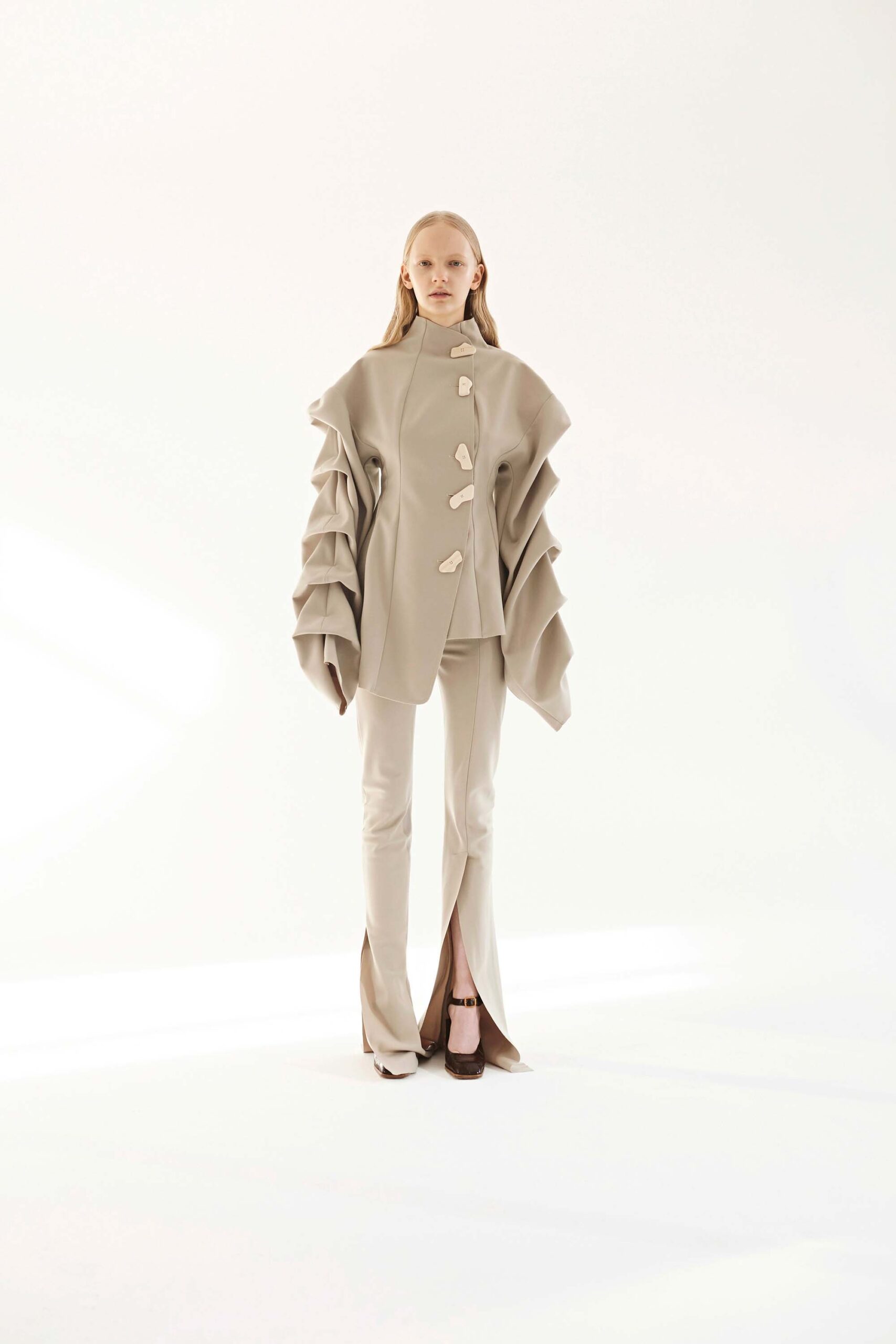 beige ruffled jacket and flared pants