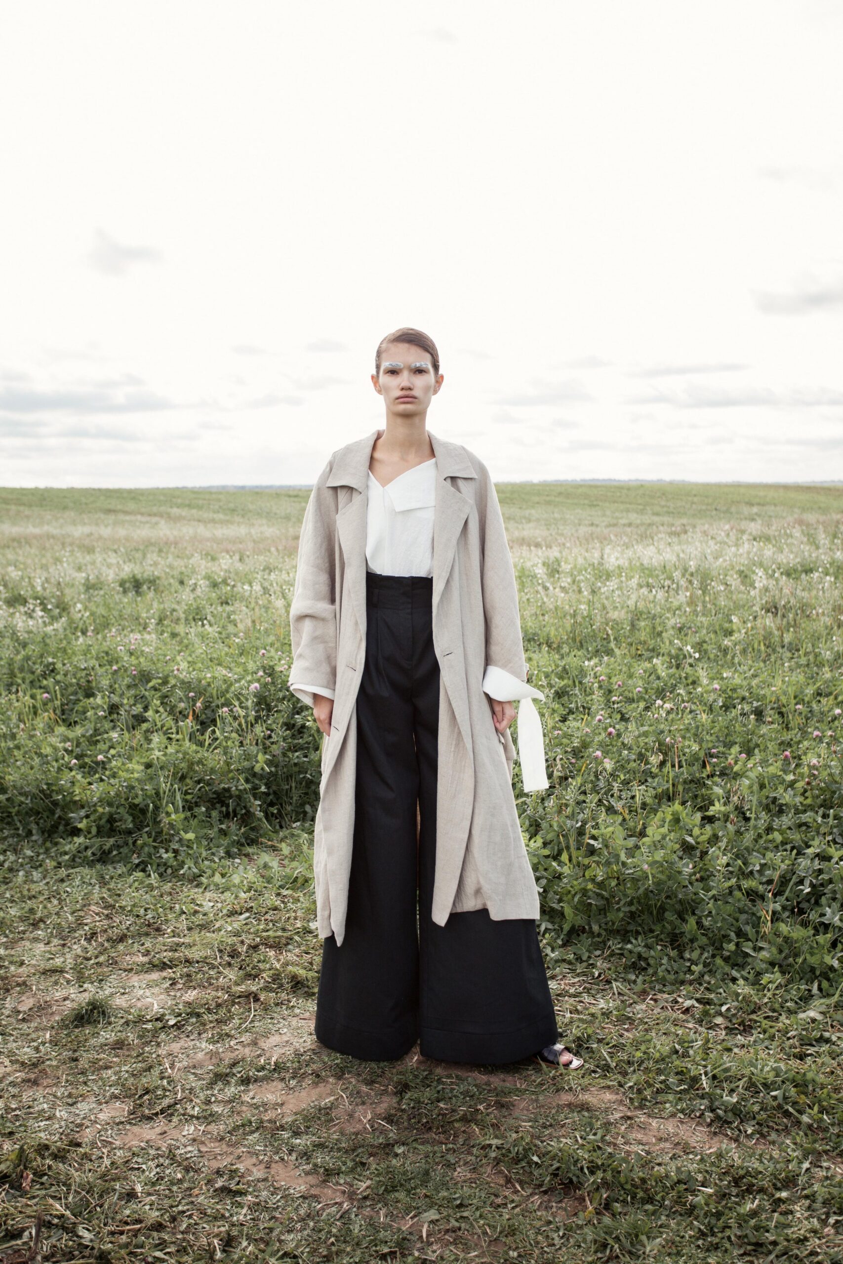 beige coat white blouse black pants