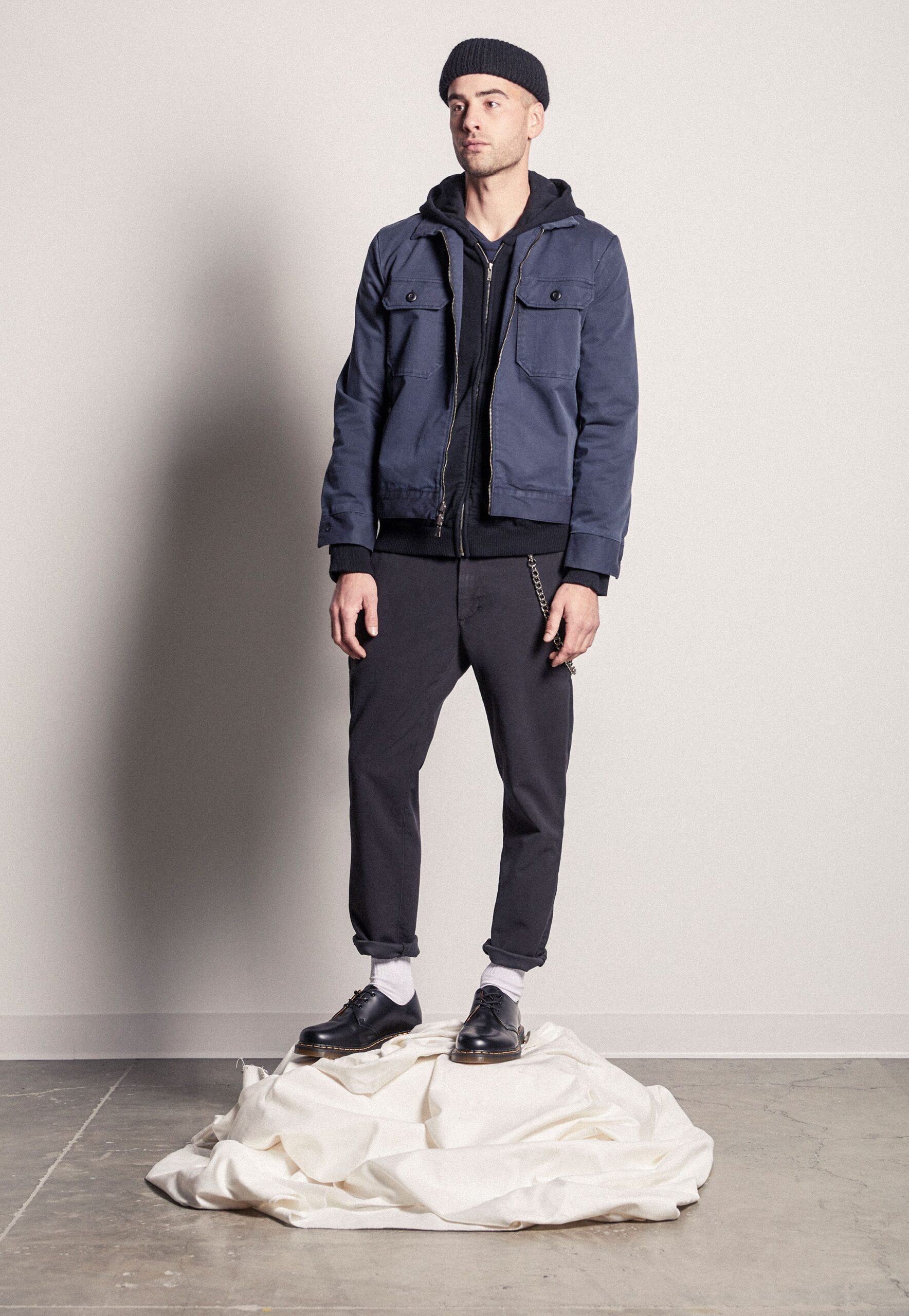 blue jacket black hoodie black pants