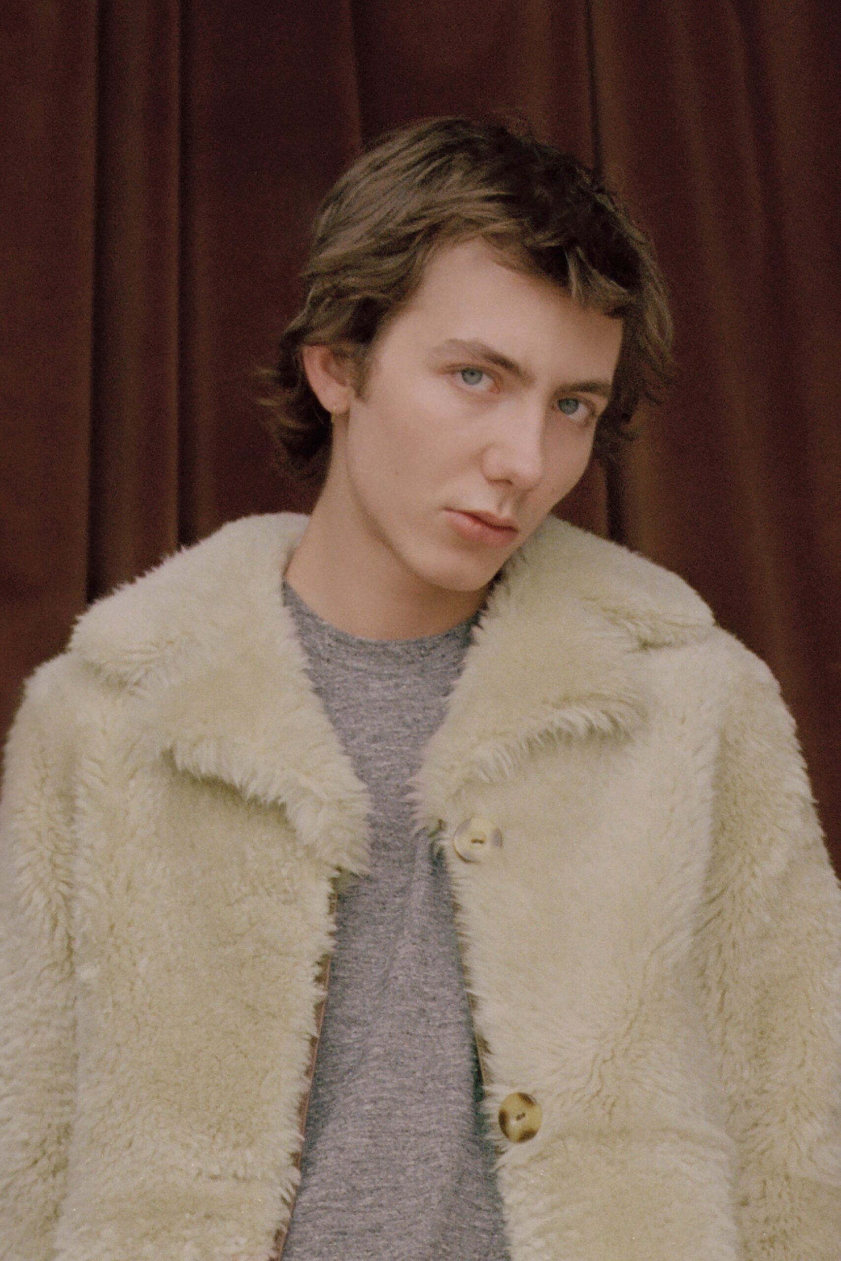 beige faux-fur coat and gray top