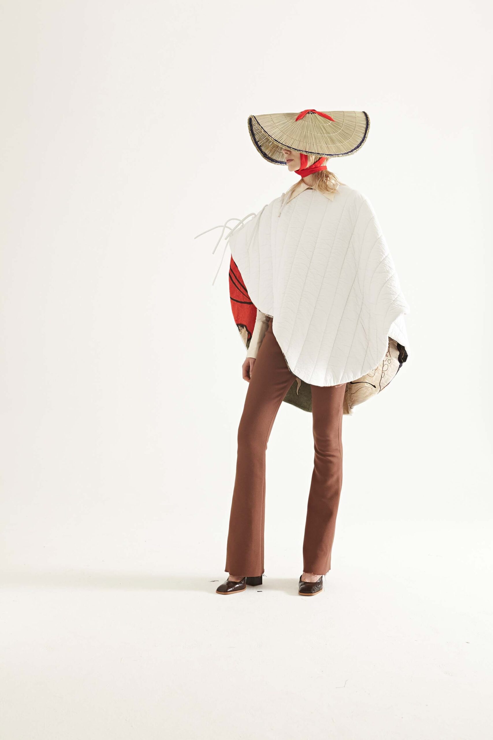 white cotton poncho and brown pants