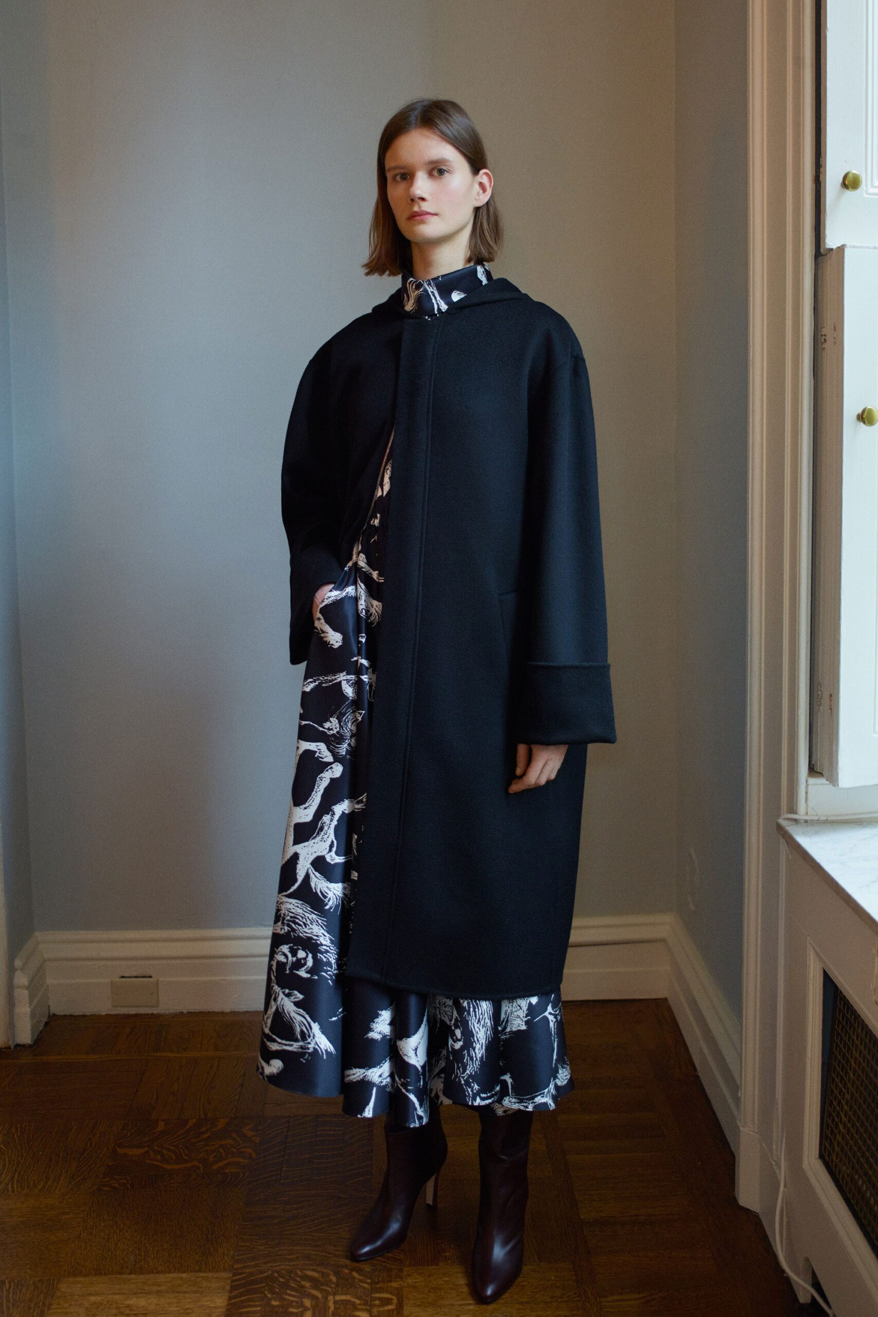 black oversized coat and flared dress