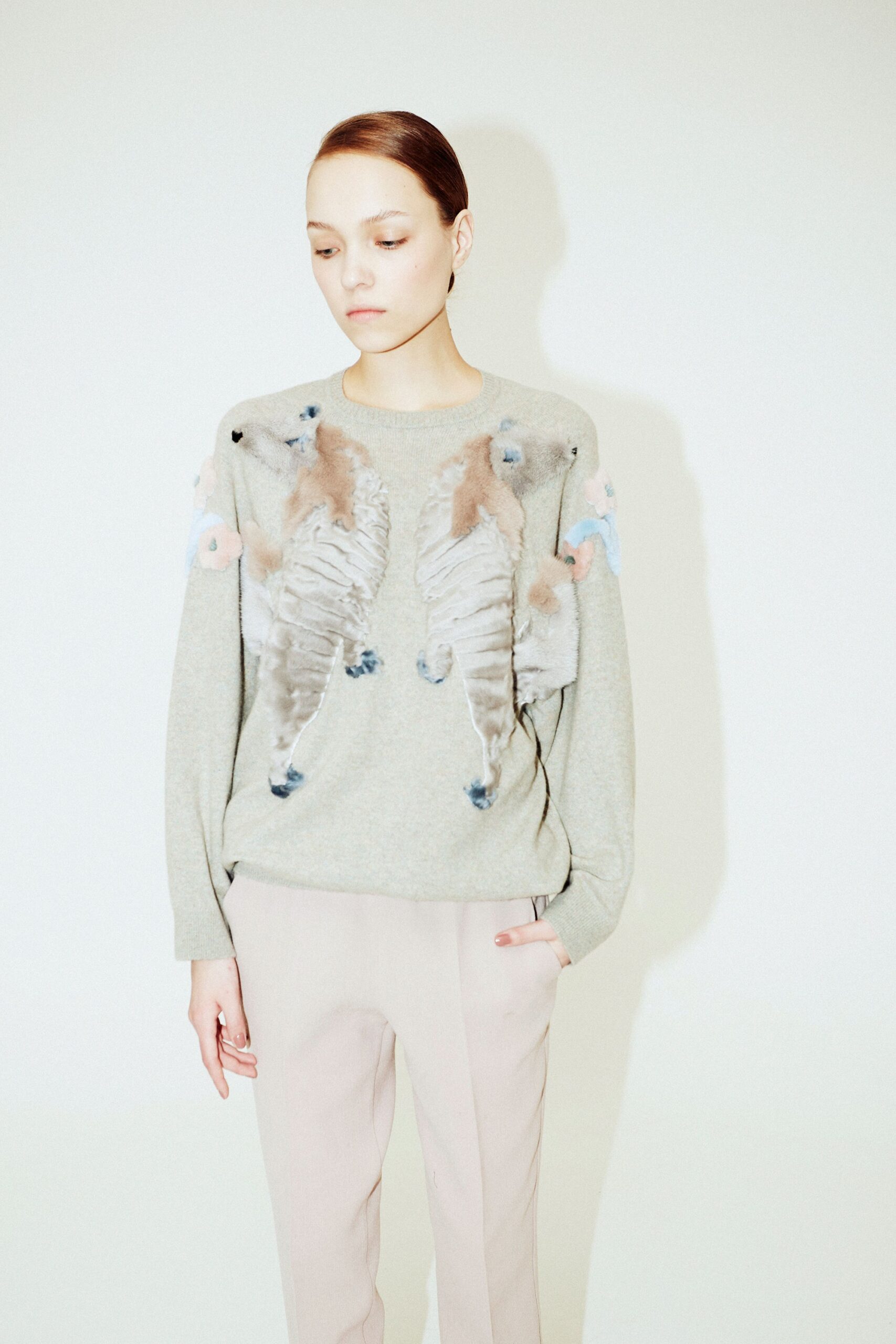 gray embroidered sweater with beige pants