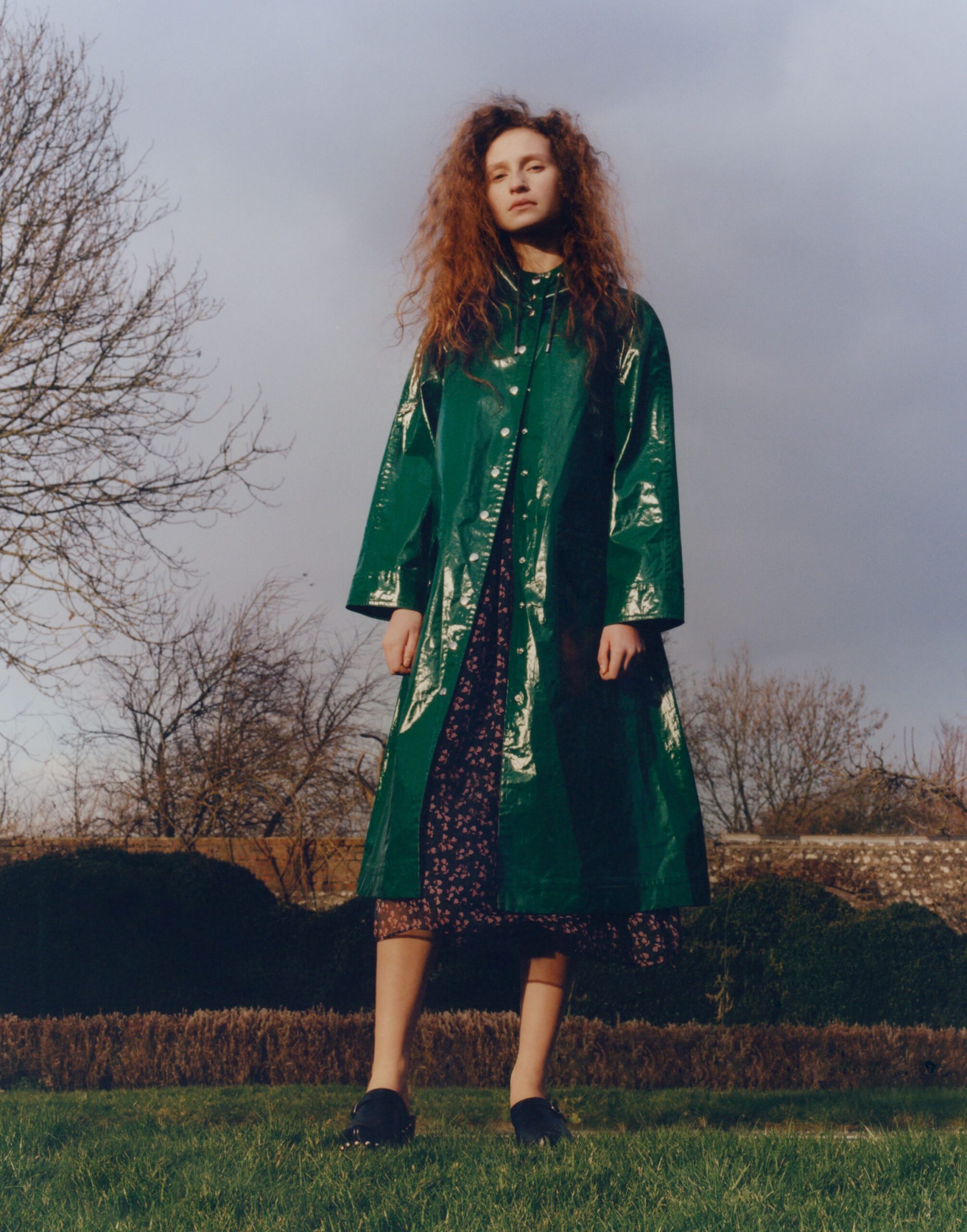 green vinyl coat with black dress