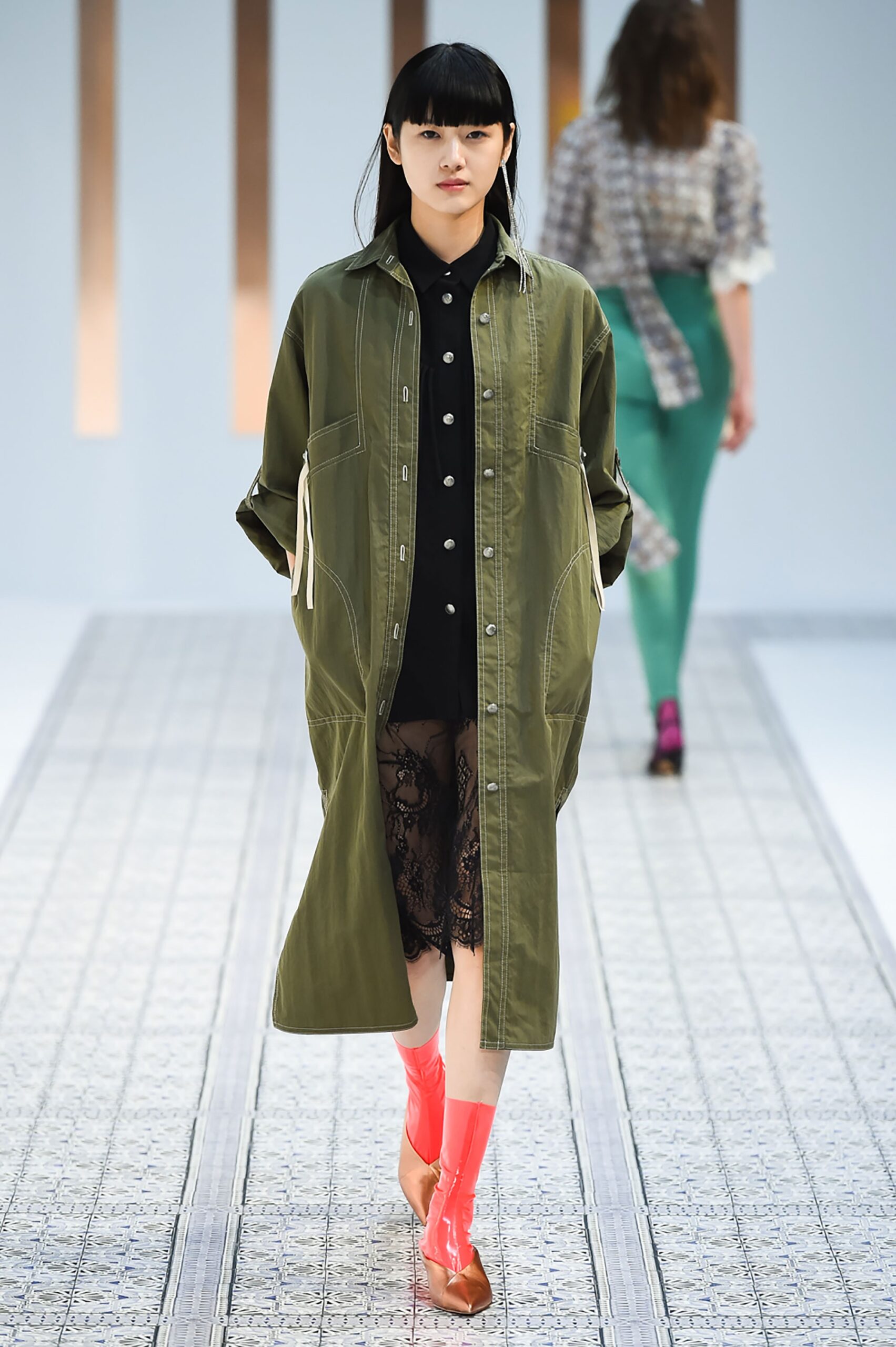 A relaxed green long-sleeve dress with a collared neckline and buttoned front.