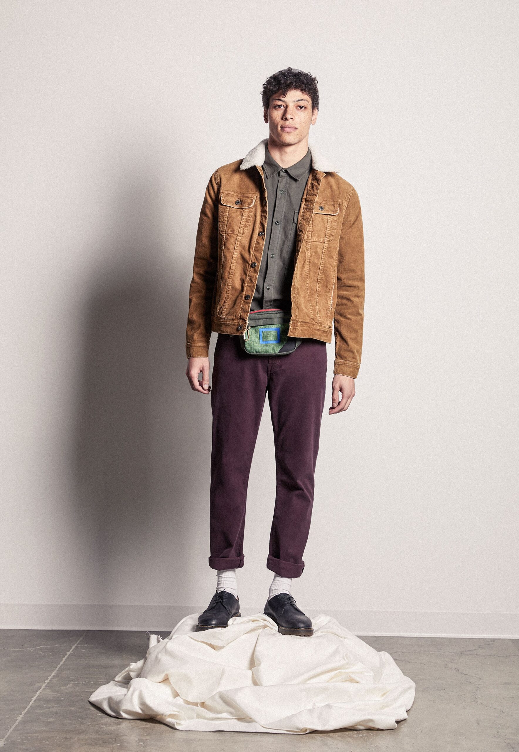 brown jacket gray shirt purple pants
