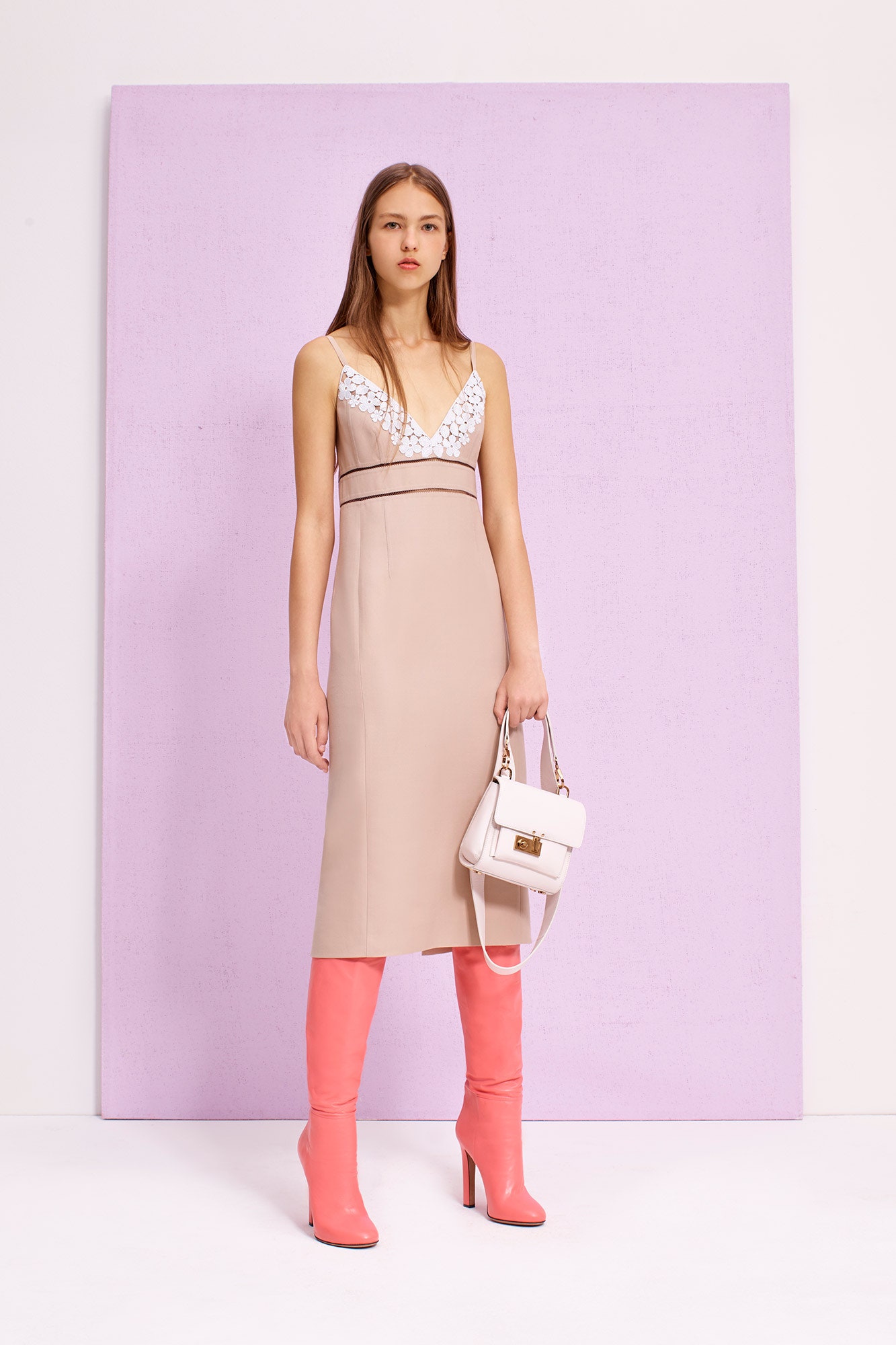 beige fitted sleeveless dress with pink boots