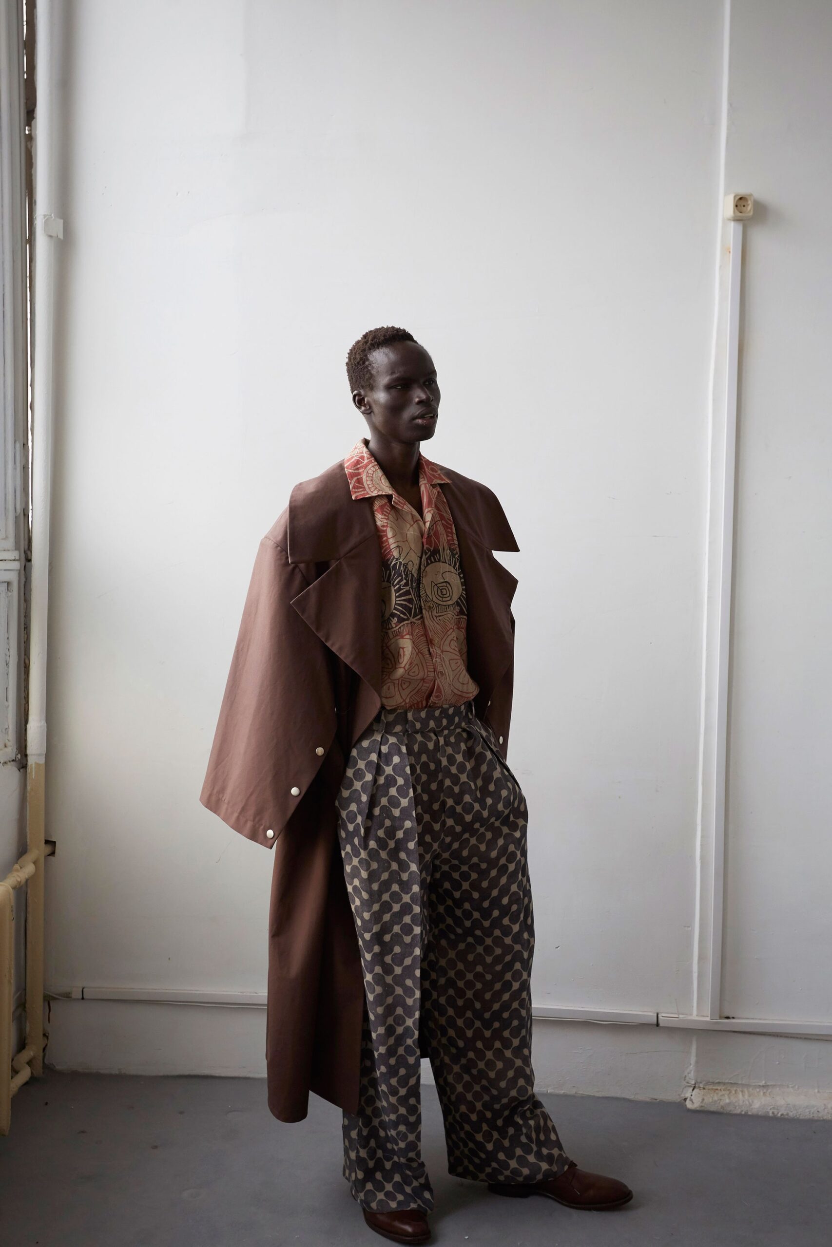 brown coat with printed shirt and pants