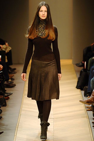 black fitted top and pleated skirt