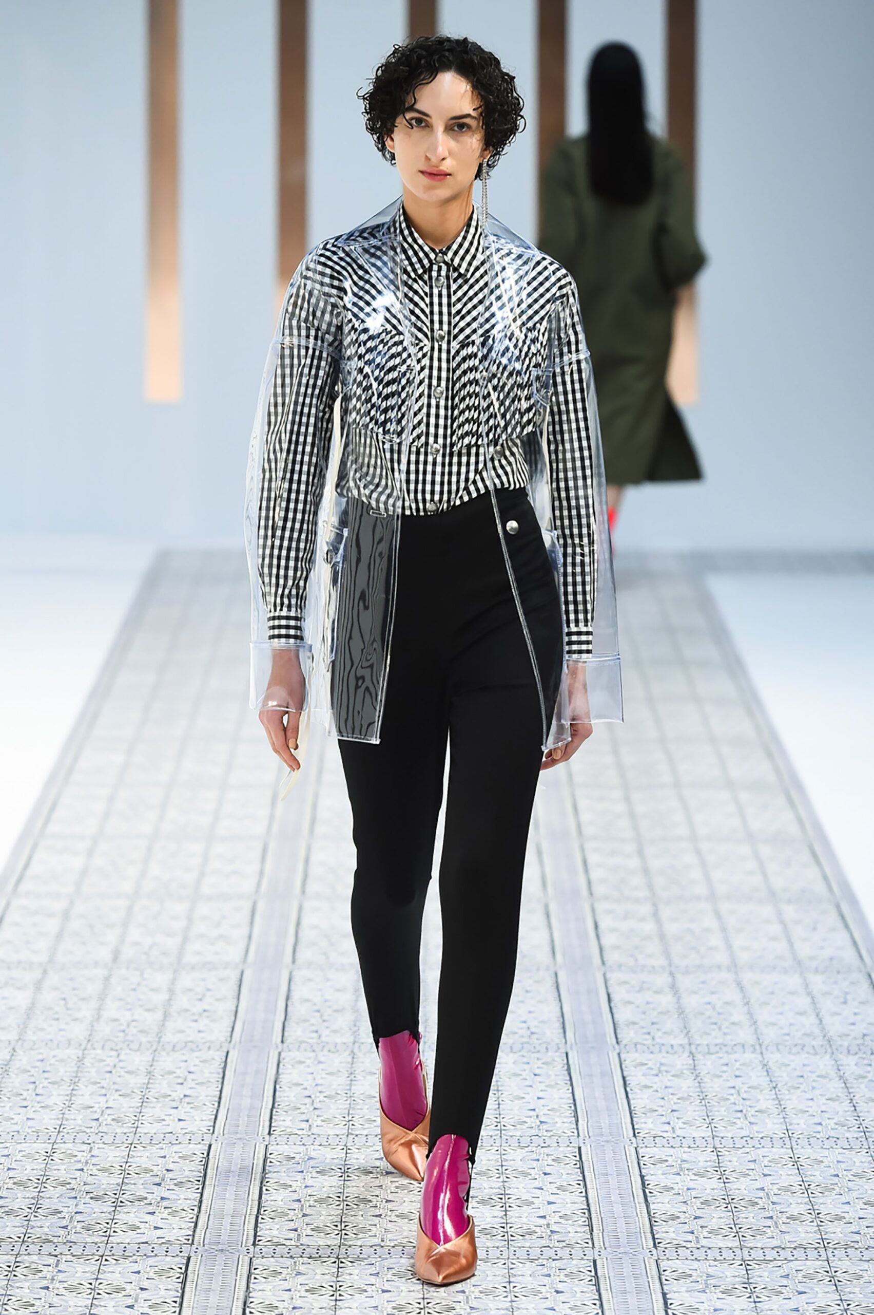 A fitted black and white striped long-sleeve shirt paired with sleek black pants.